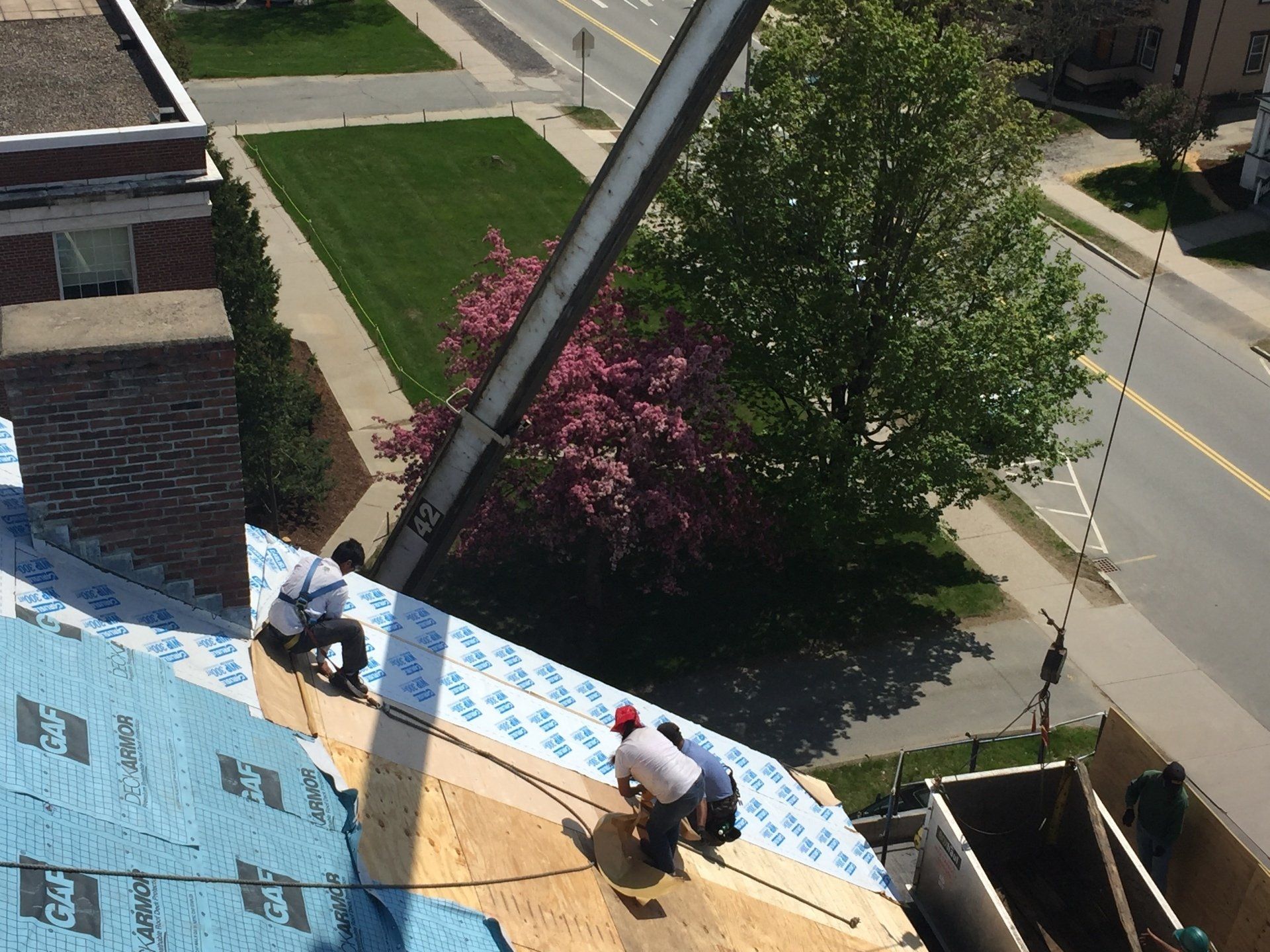 A group of men are working on the roof of a building