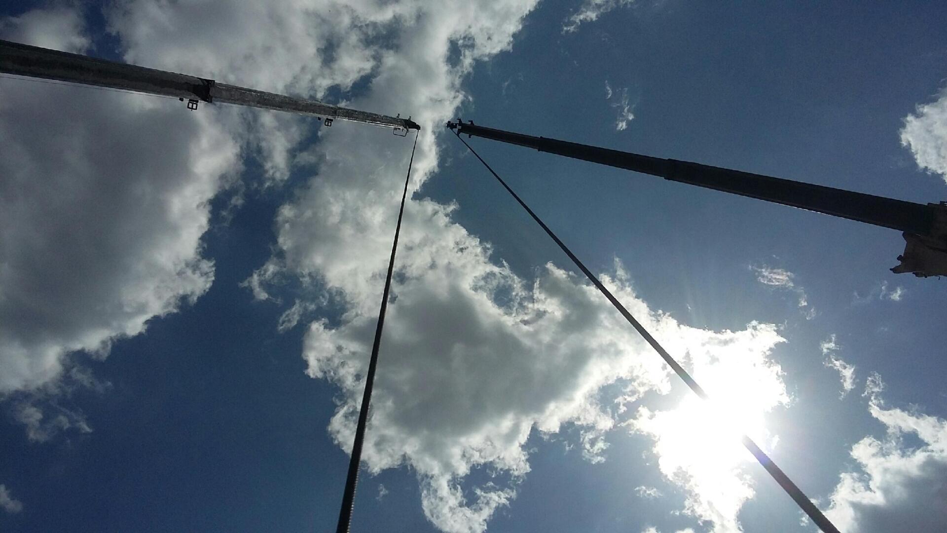 The sun is shining through the clouds on a sunny day