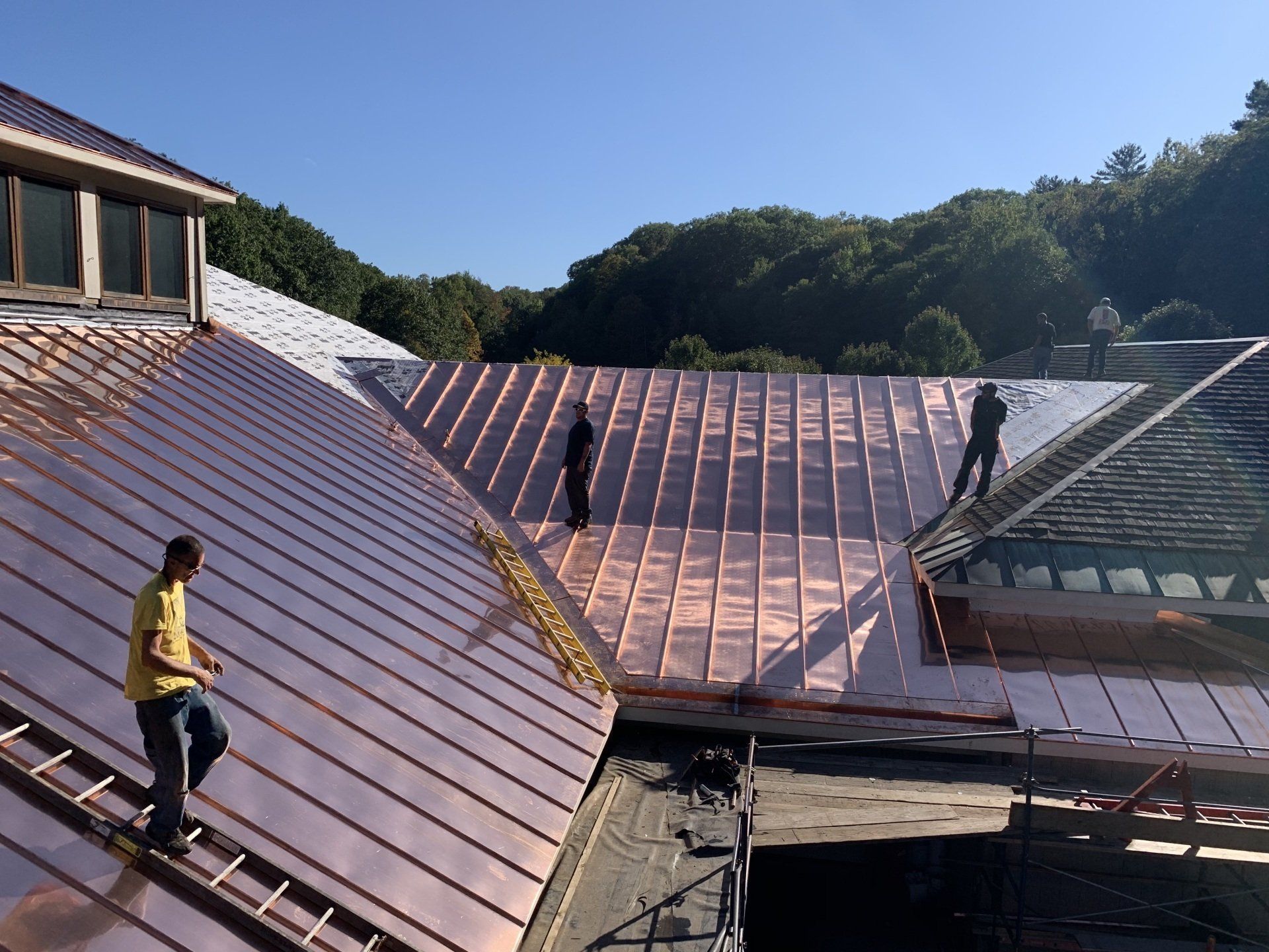 A copper roof is being installed on a building