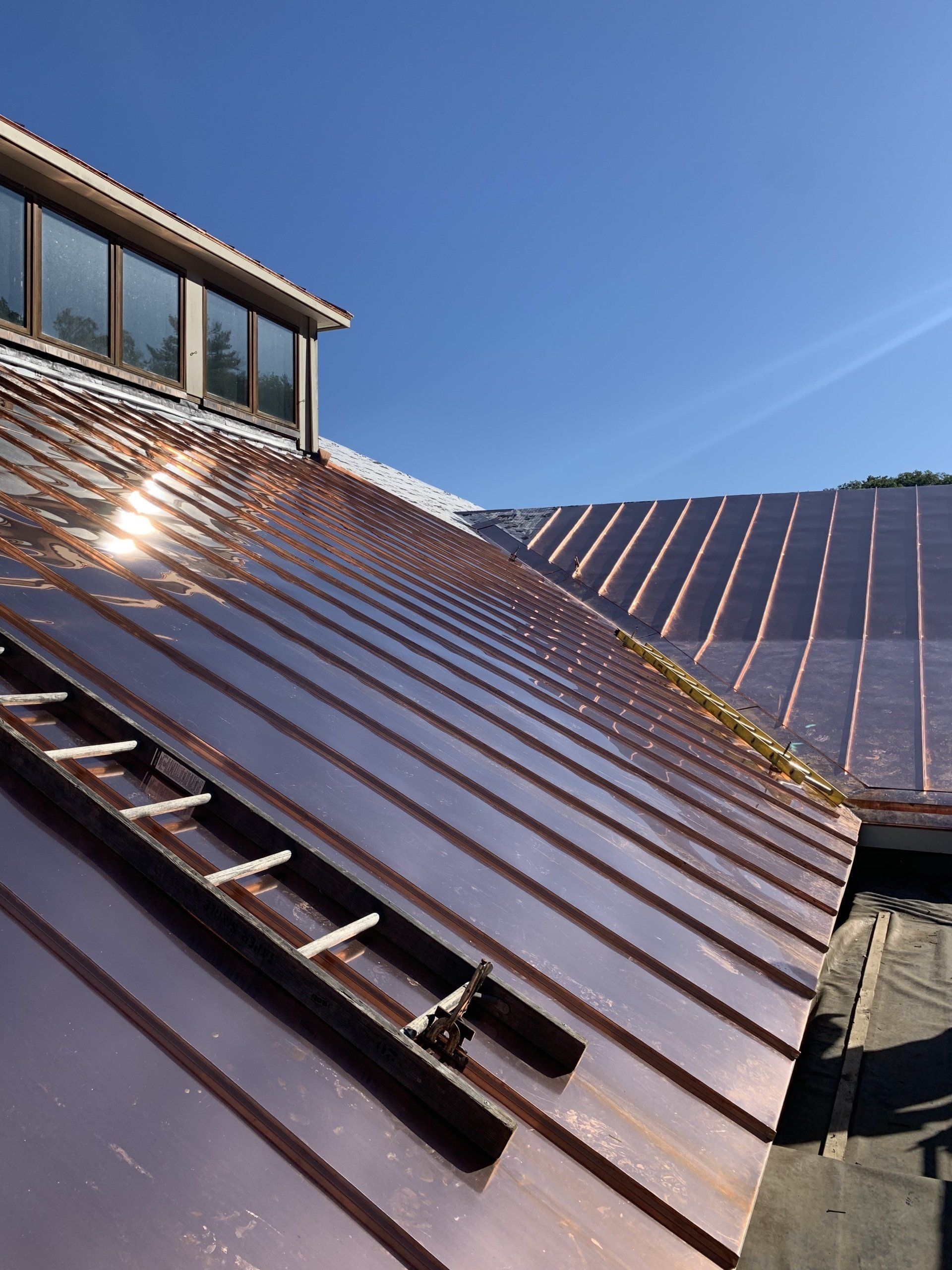 Copper standing seam roof on a Vermont home installed by roofing contractors at Rodd Roofing