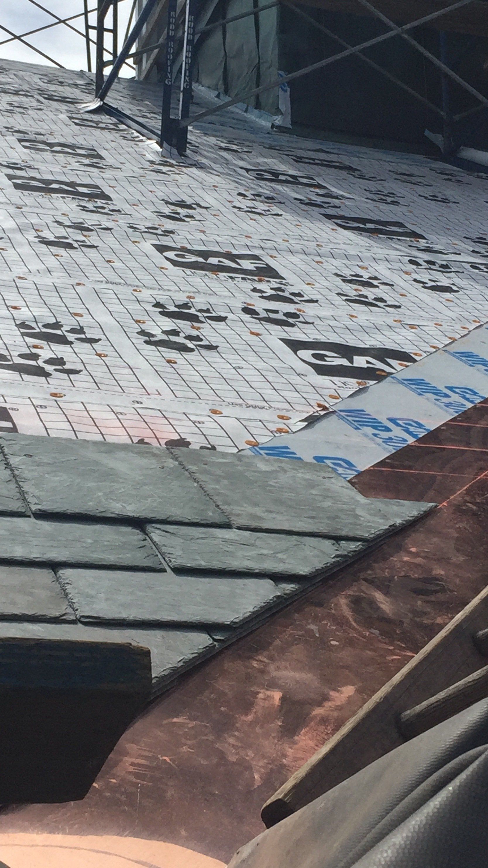 A roof with a lot of shingles on it is being built.
