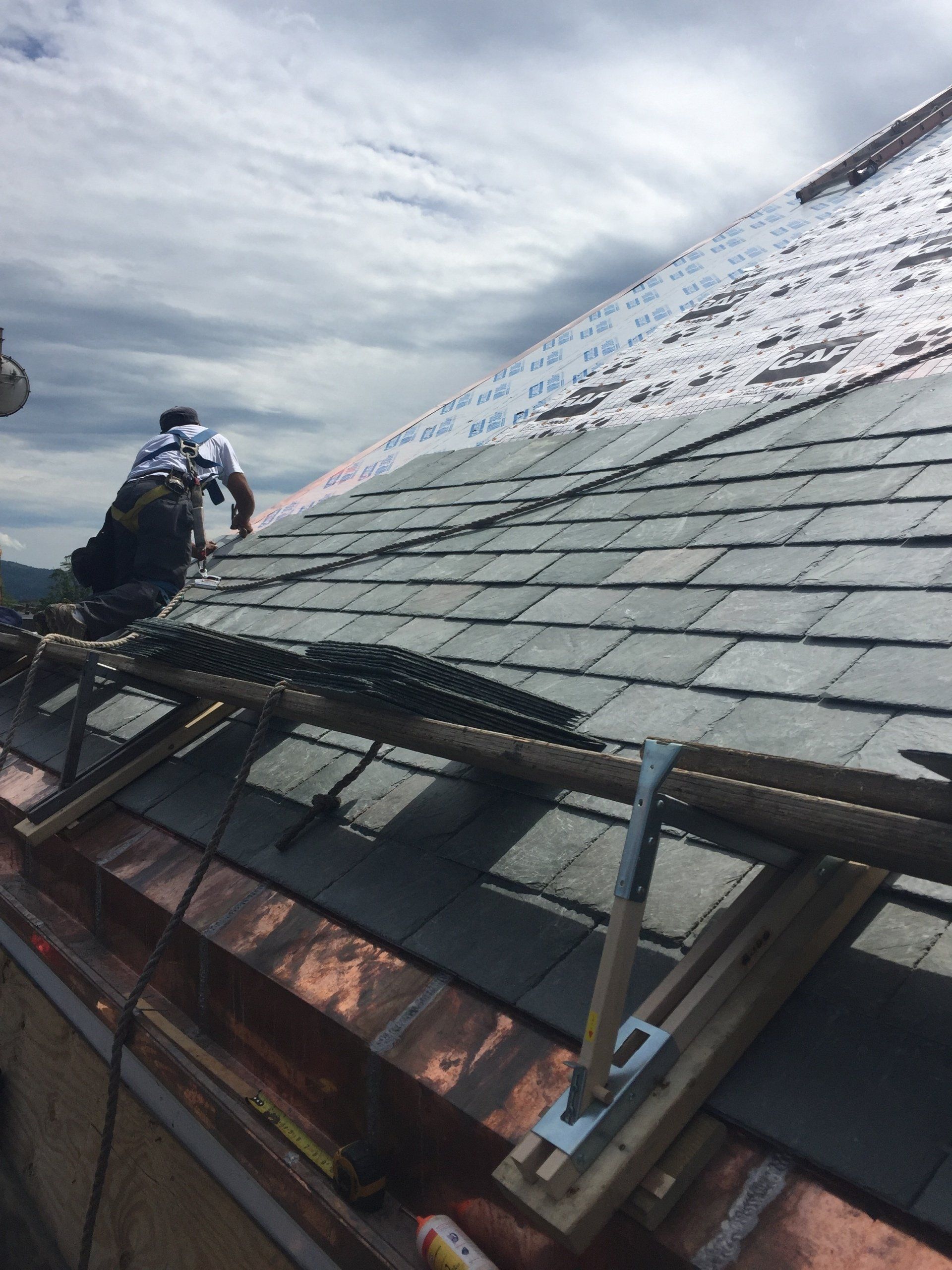 Rodd Roofing  employees installing a slate roof on  a commercial building