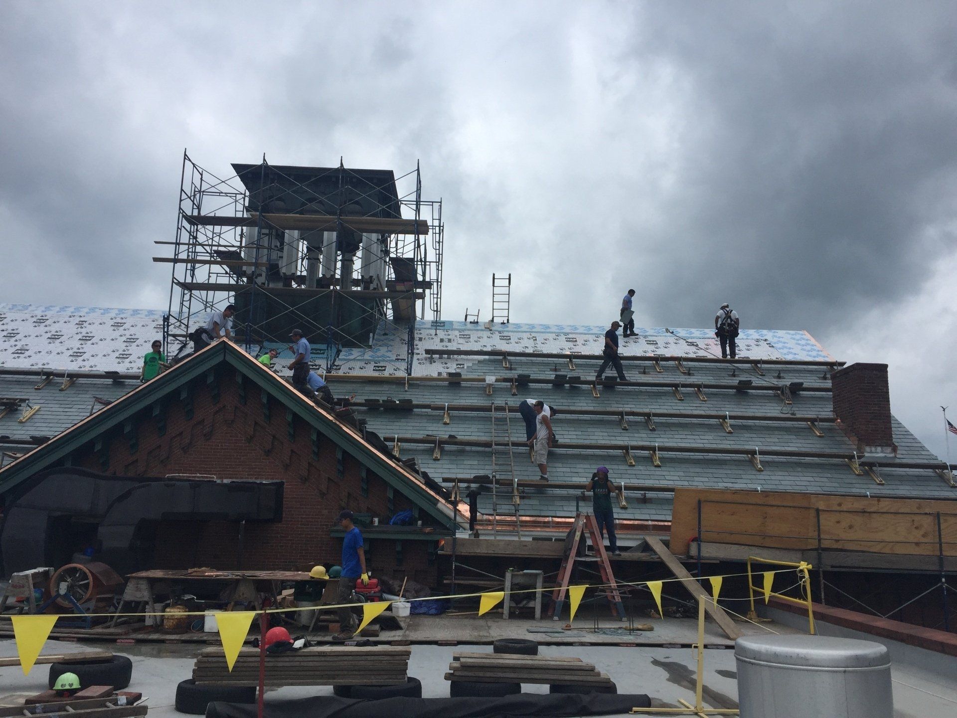 A group of people are working on the roof of a building.