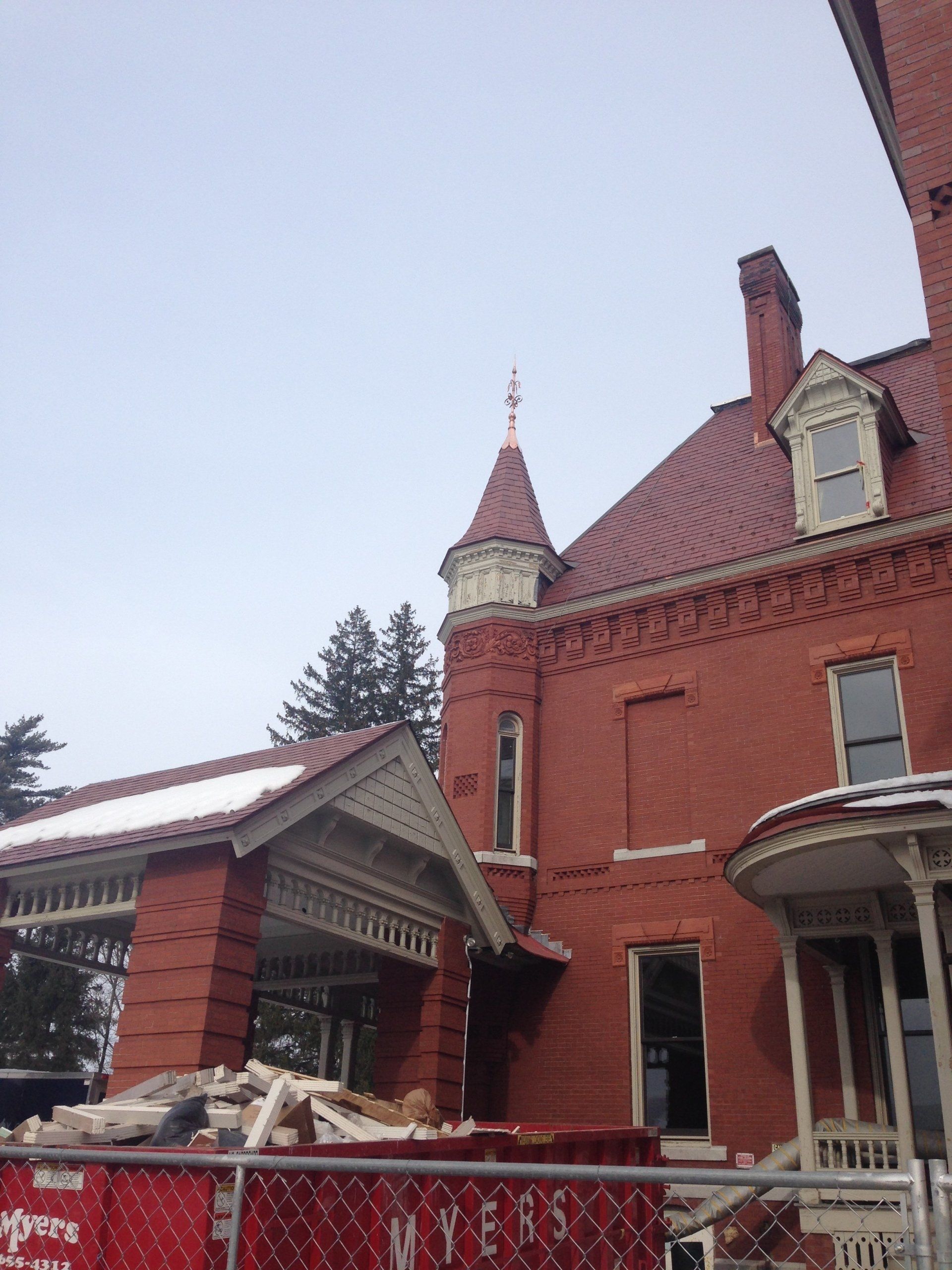 A large red brick building with a tower on top of it
