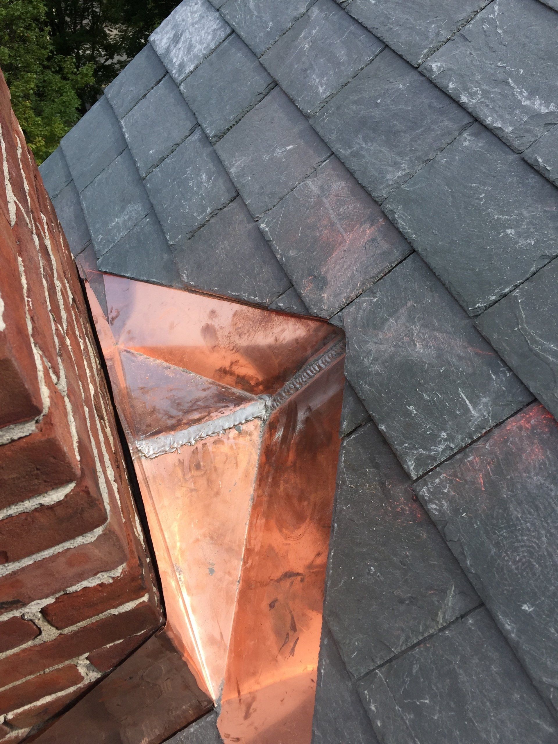 Rodd Roofing installing a slate roof with copper roofing on  a commercial building