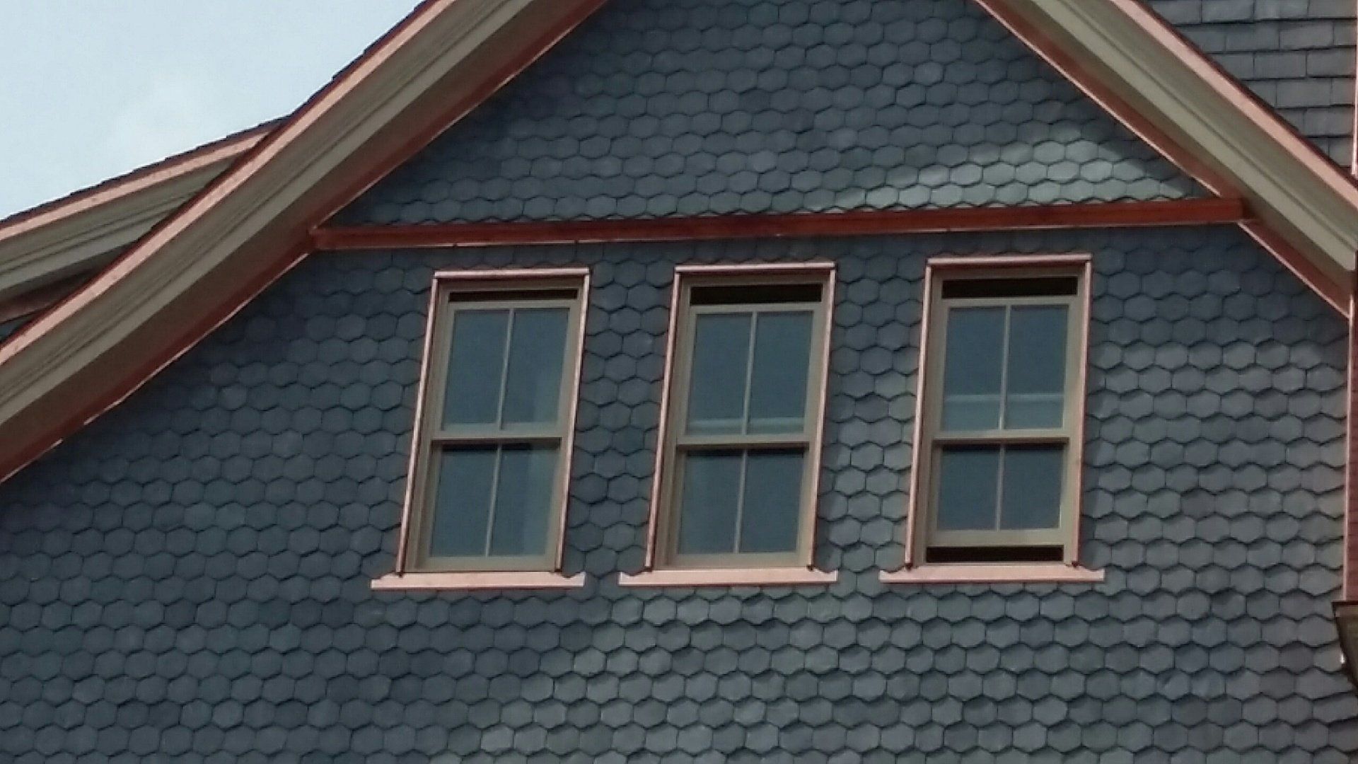 The roof of a house has three windows on it