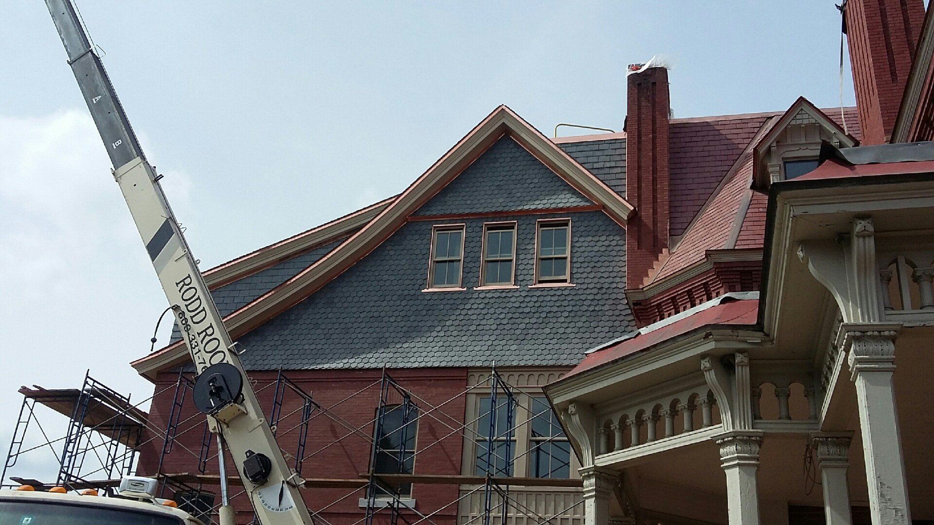 A large brick building with a crane in front of it
