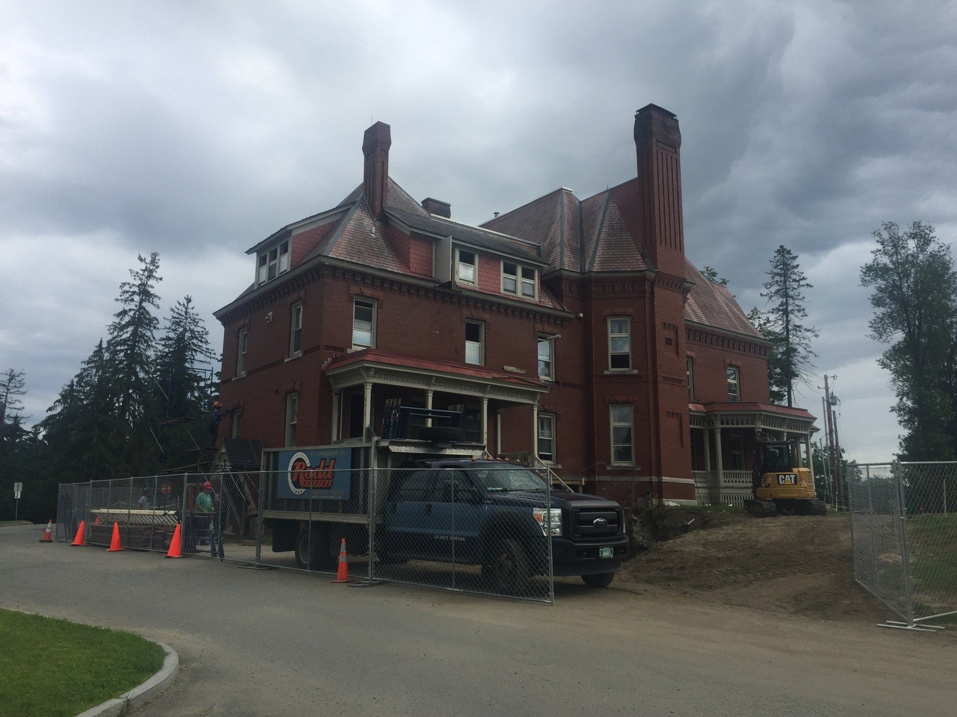 A large brick building with a truck parked in front of it.