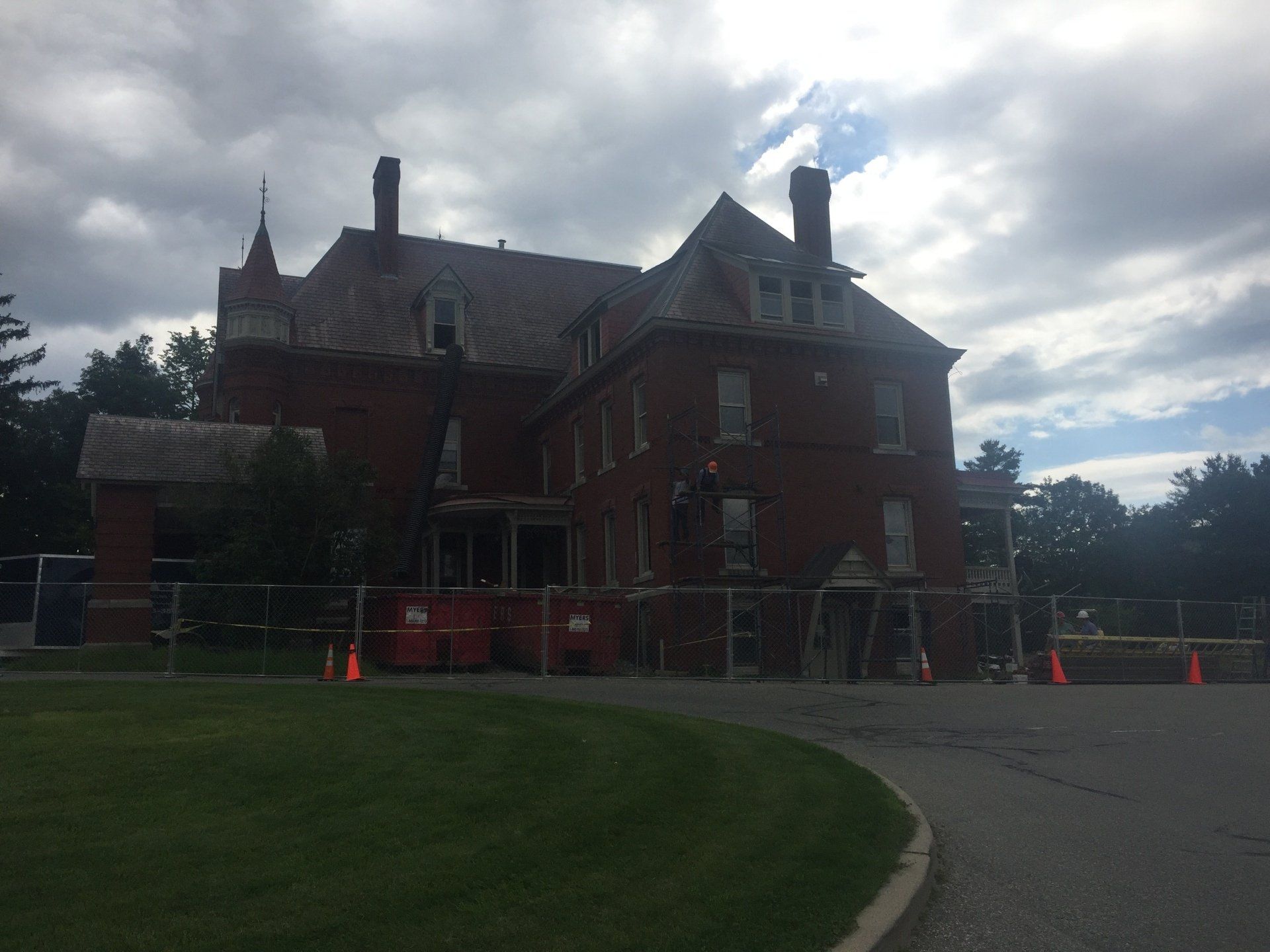 A large brick building with a fence around it