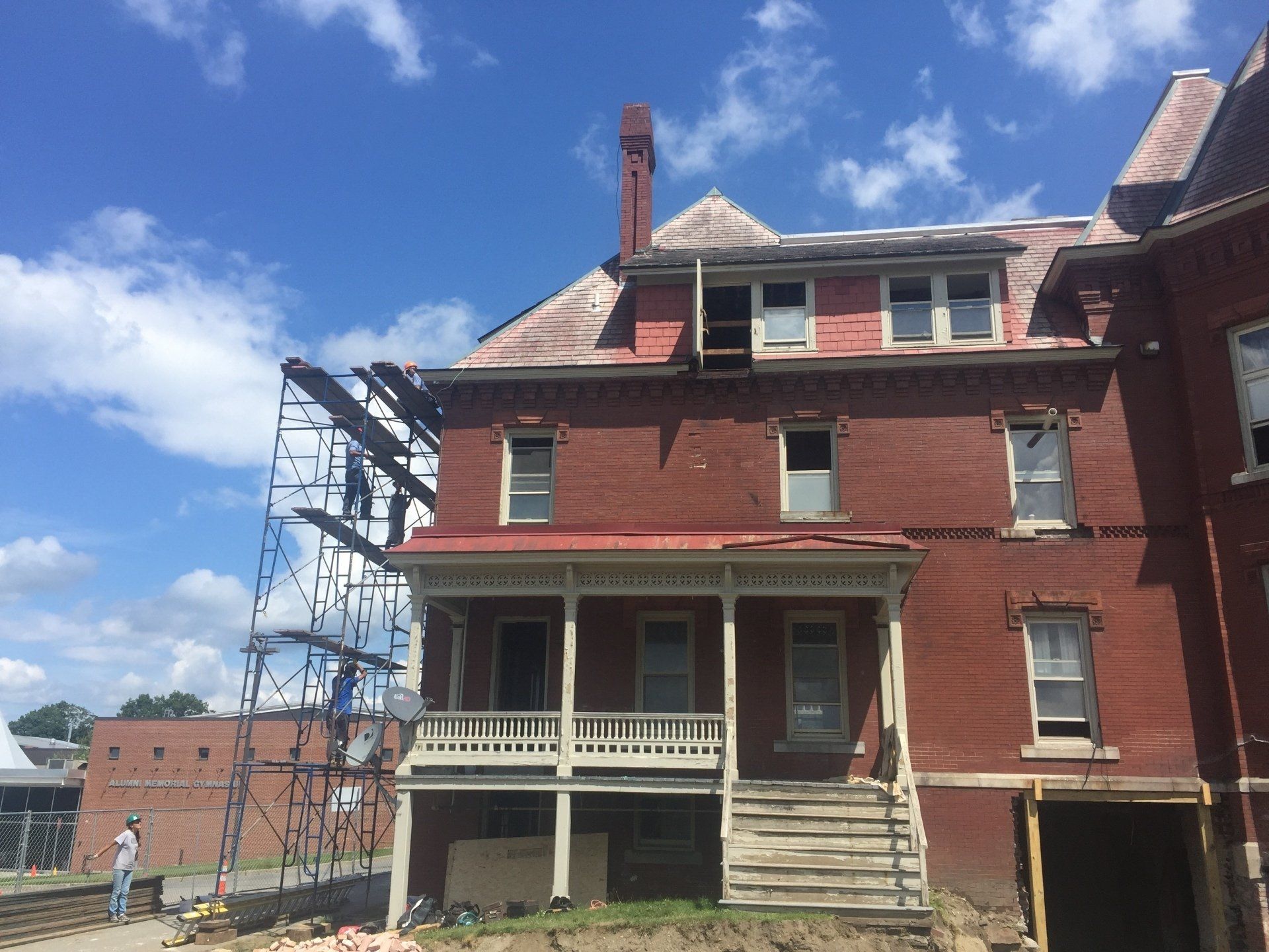 A large red brick house with scaffolding around it