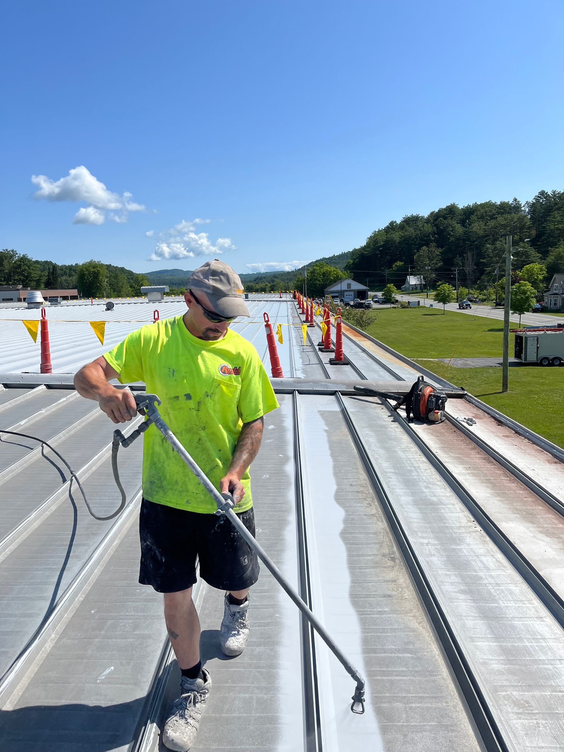 Richie Lafleur applying roof coating to commercial flat roof