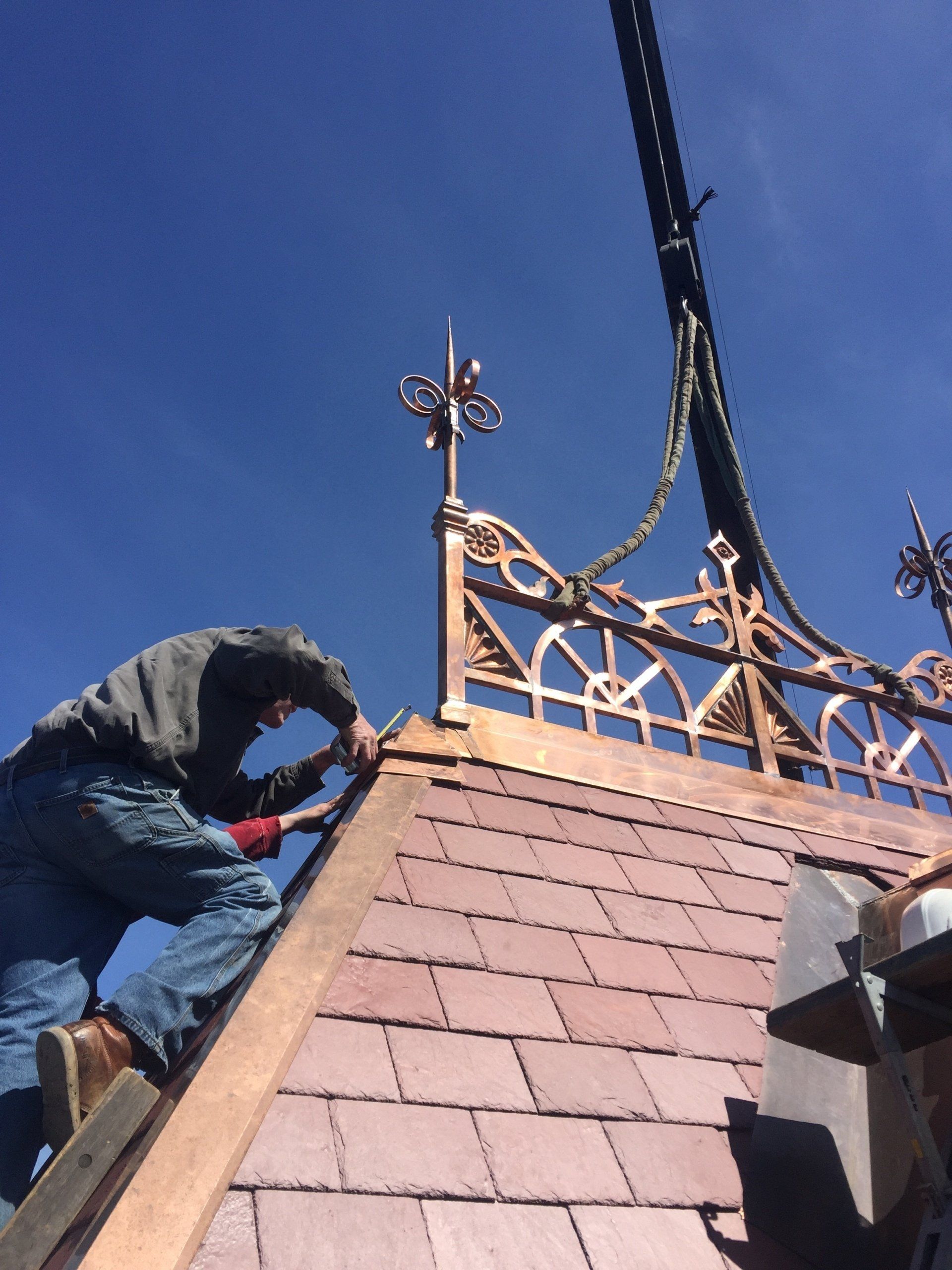 A man is working on the roof of a building