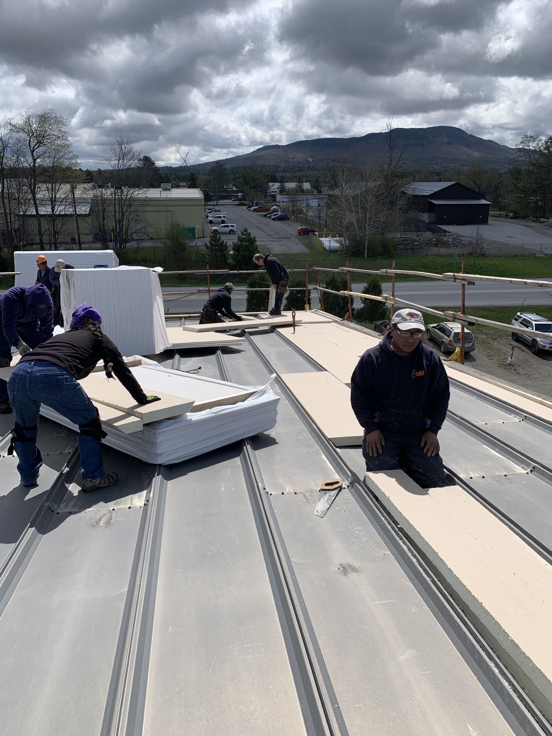 A group of people are working on a roof.