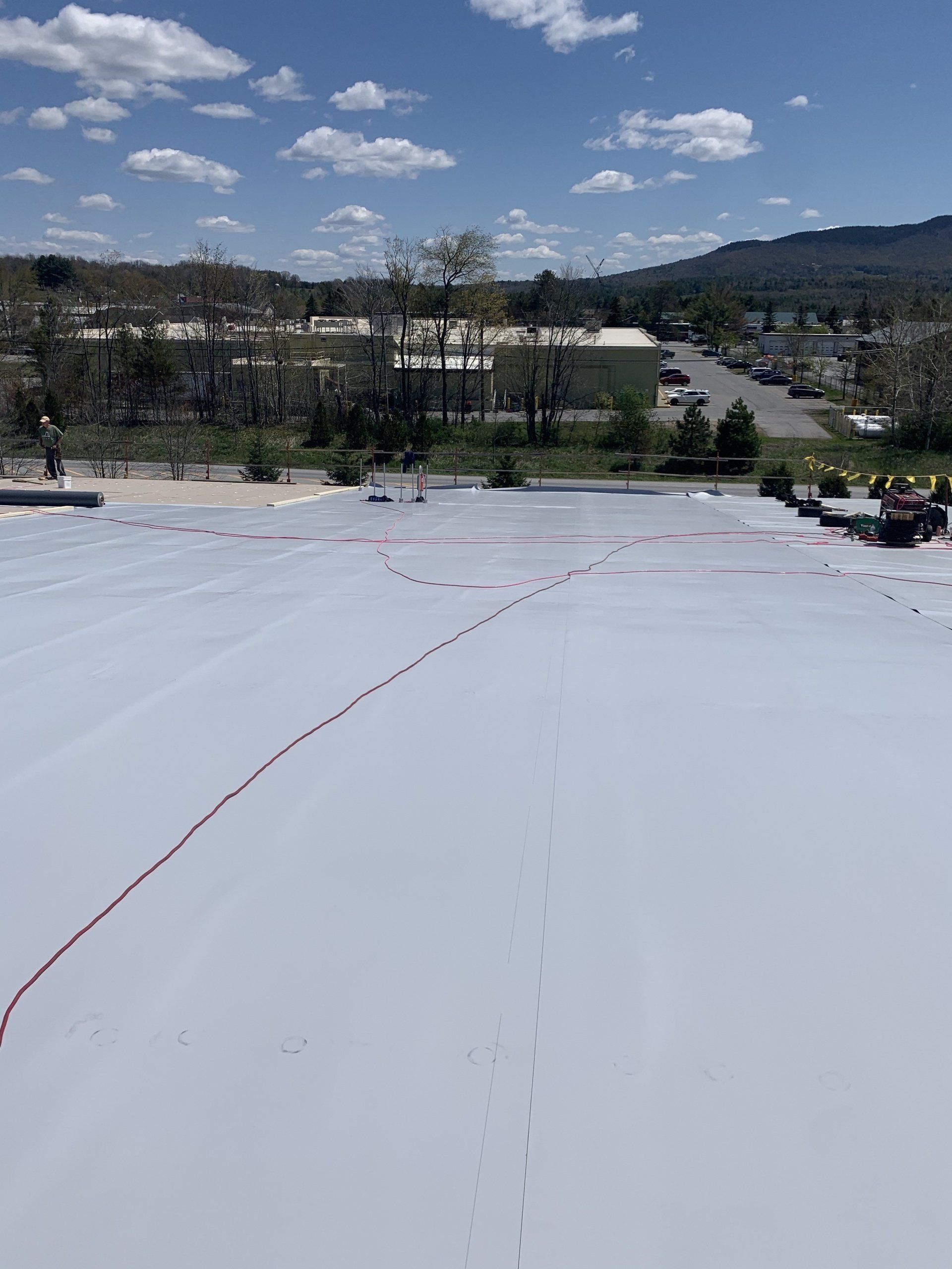 A commercial flat roof in Vermont in process of repair by Rodd Roofing.
