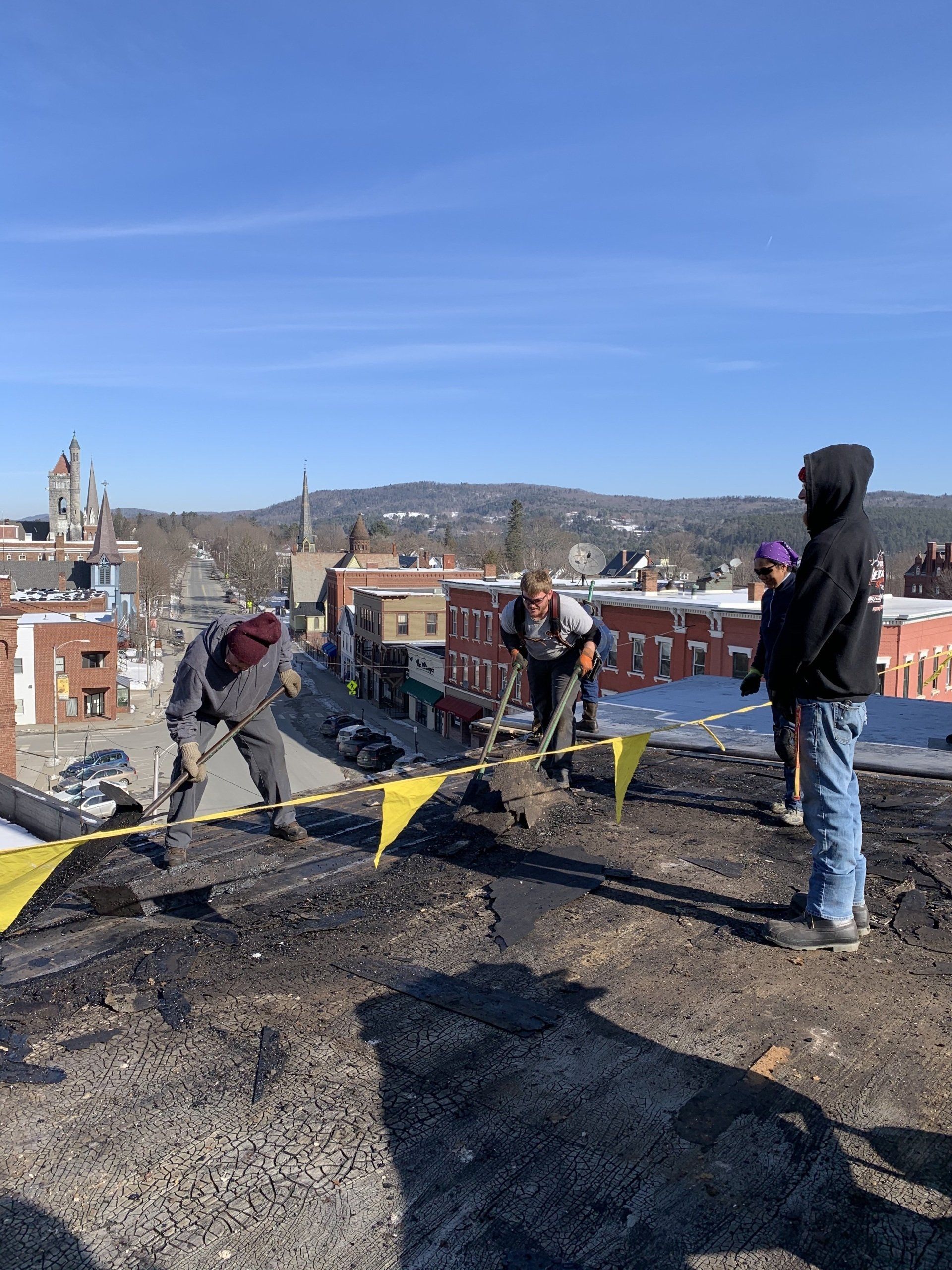 Rodd Roofing employees repairing a damamaged commercial roof