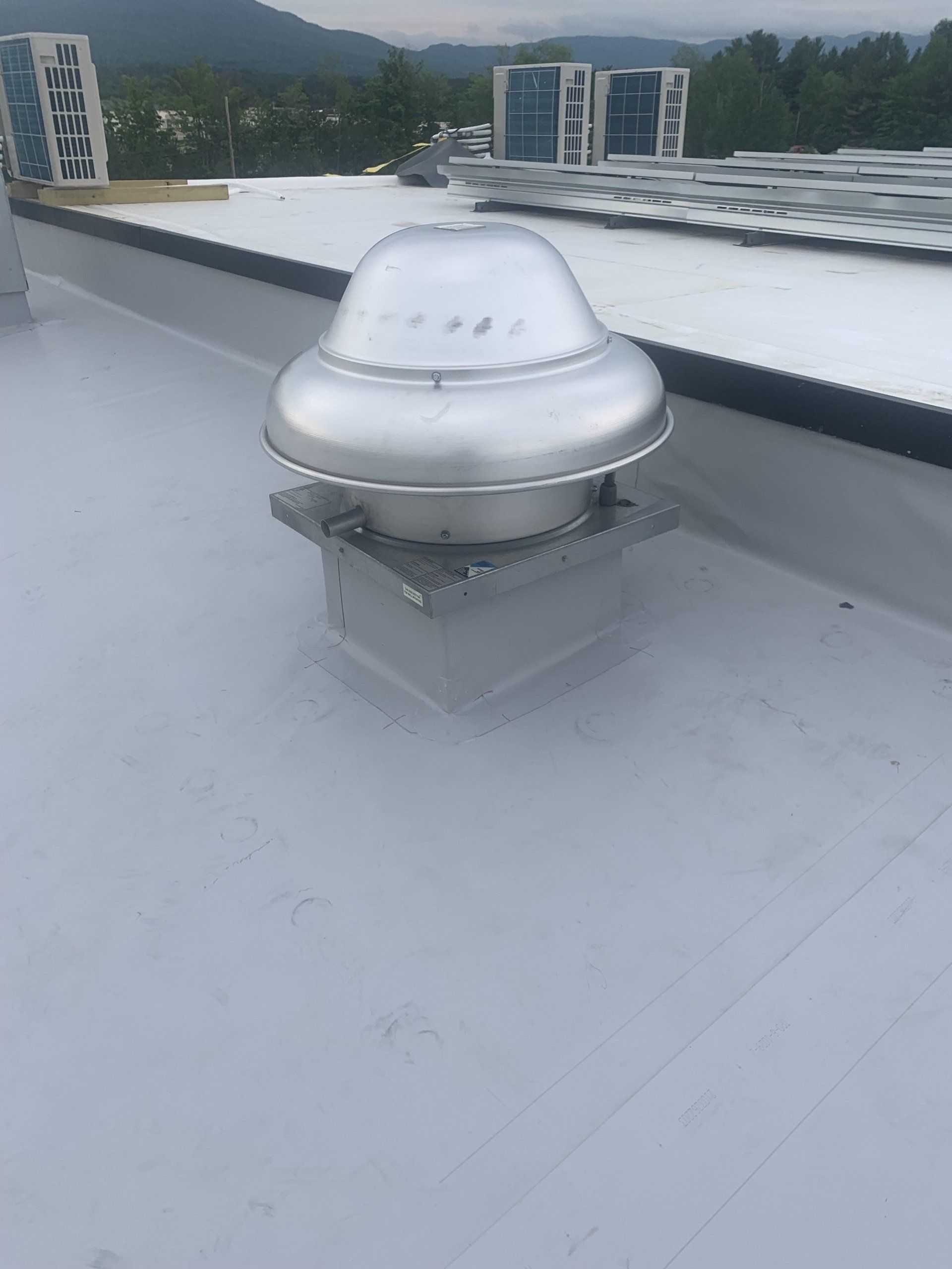 Close-up of a Metal Roof Retrofit with a ventilation dome, signifying efficient roofing.