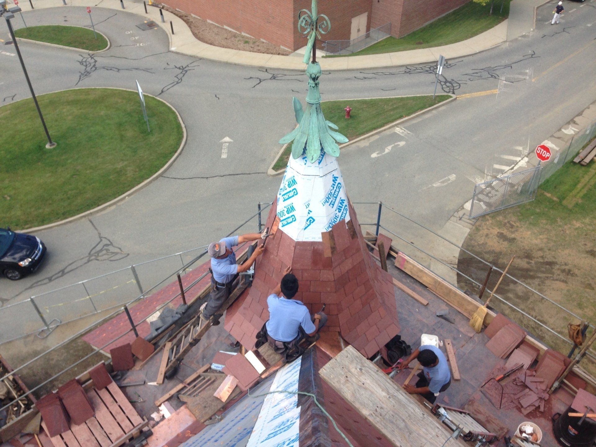 A group of men are working on the roof of a building