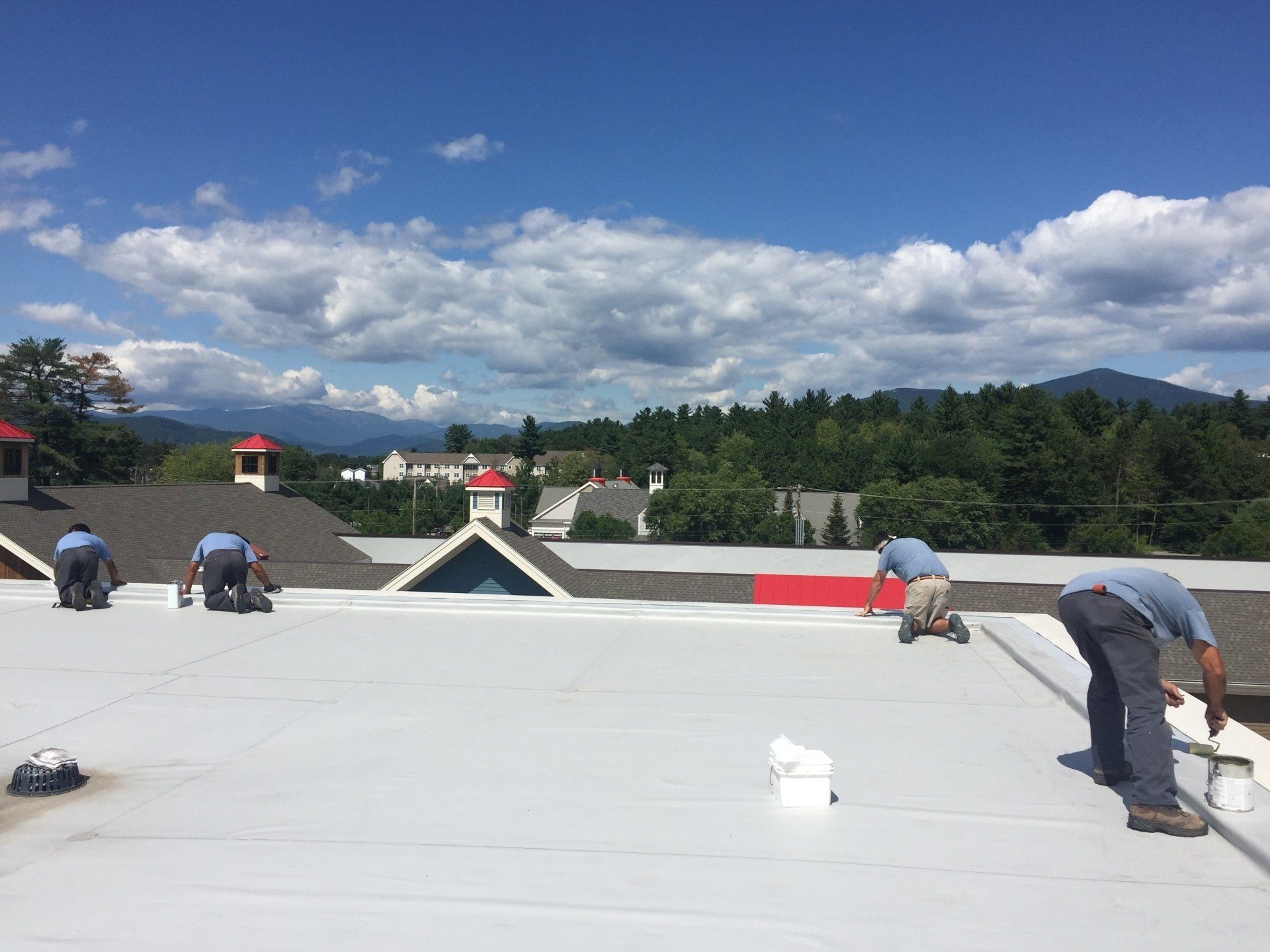 A group of men are working on a roof.