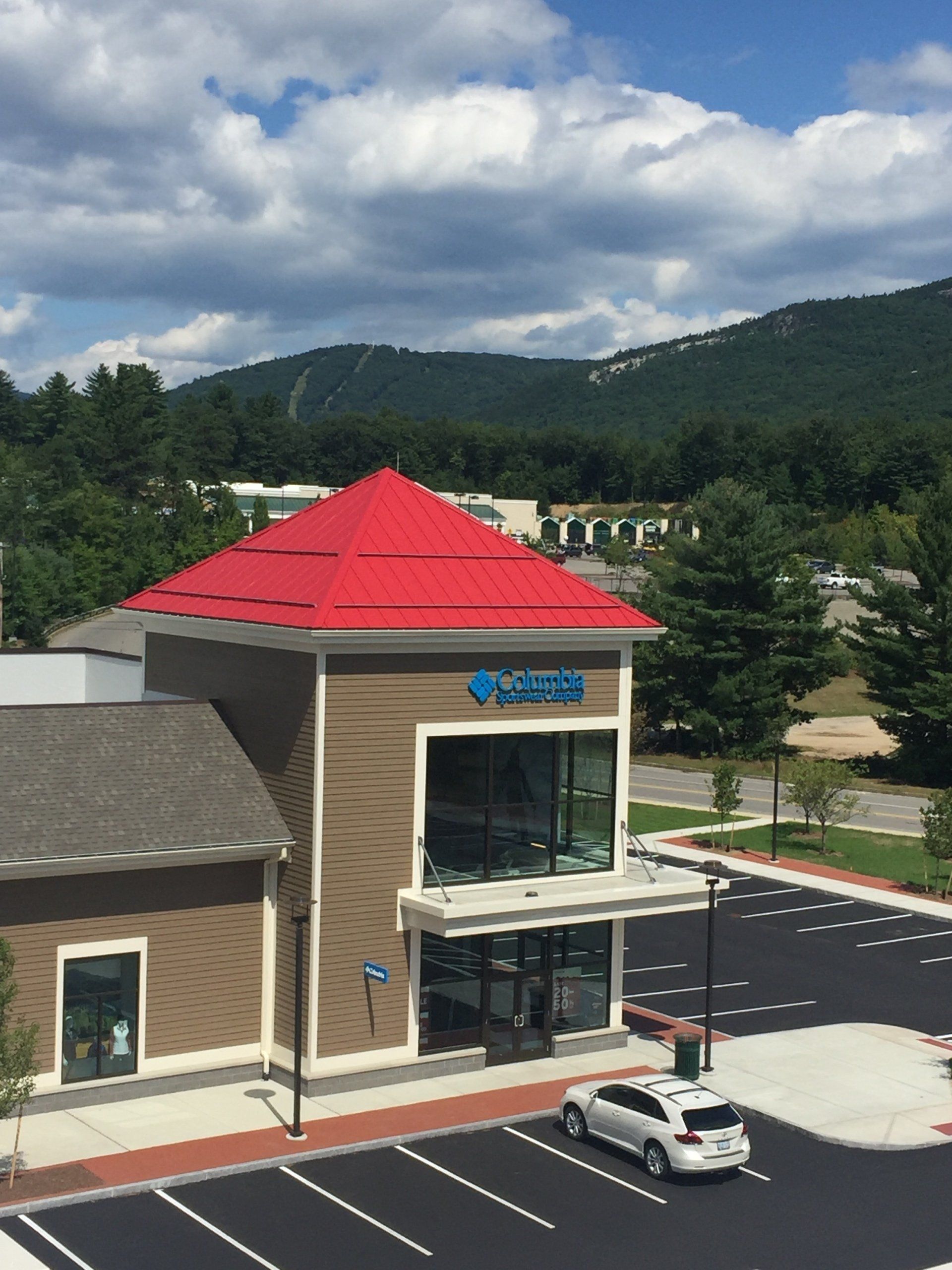 An aerial view of a building with a red roof