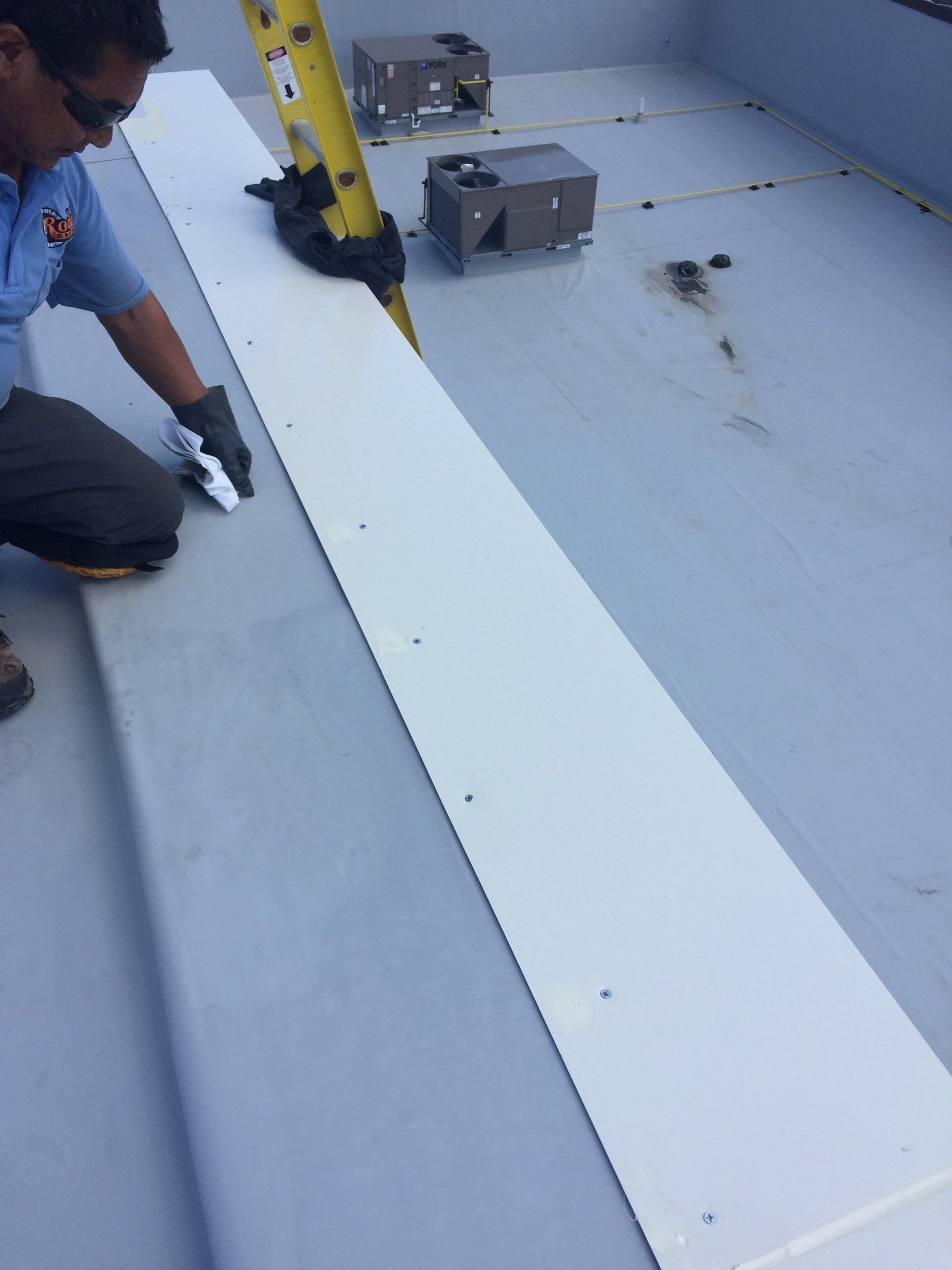 Rodd Roofing employees installing a single-ply roof in  New Hampshire
