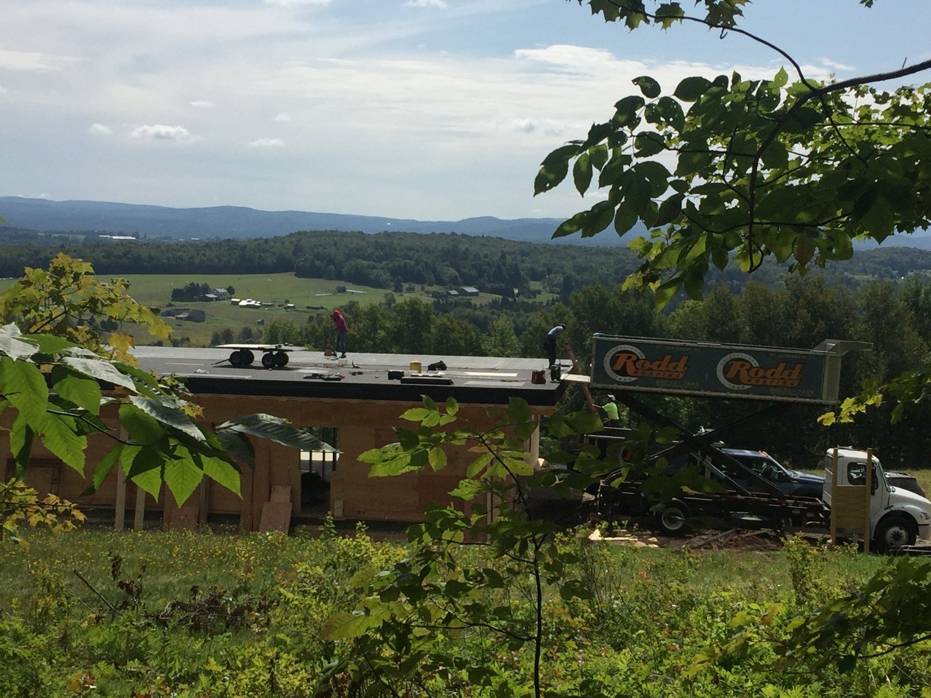 A building is being built in the middle of a field.