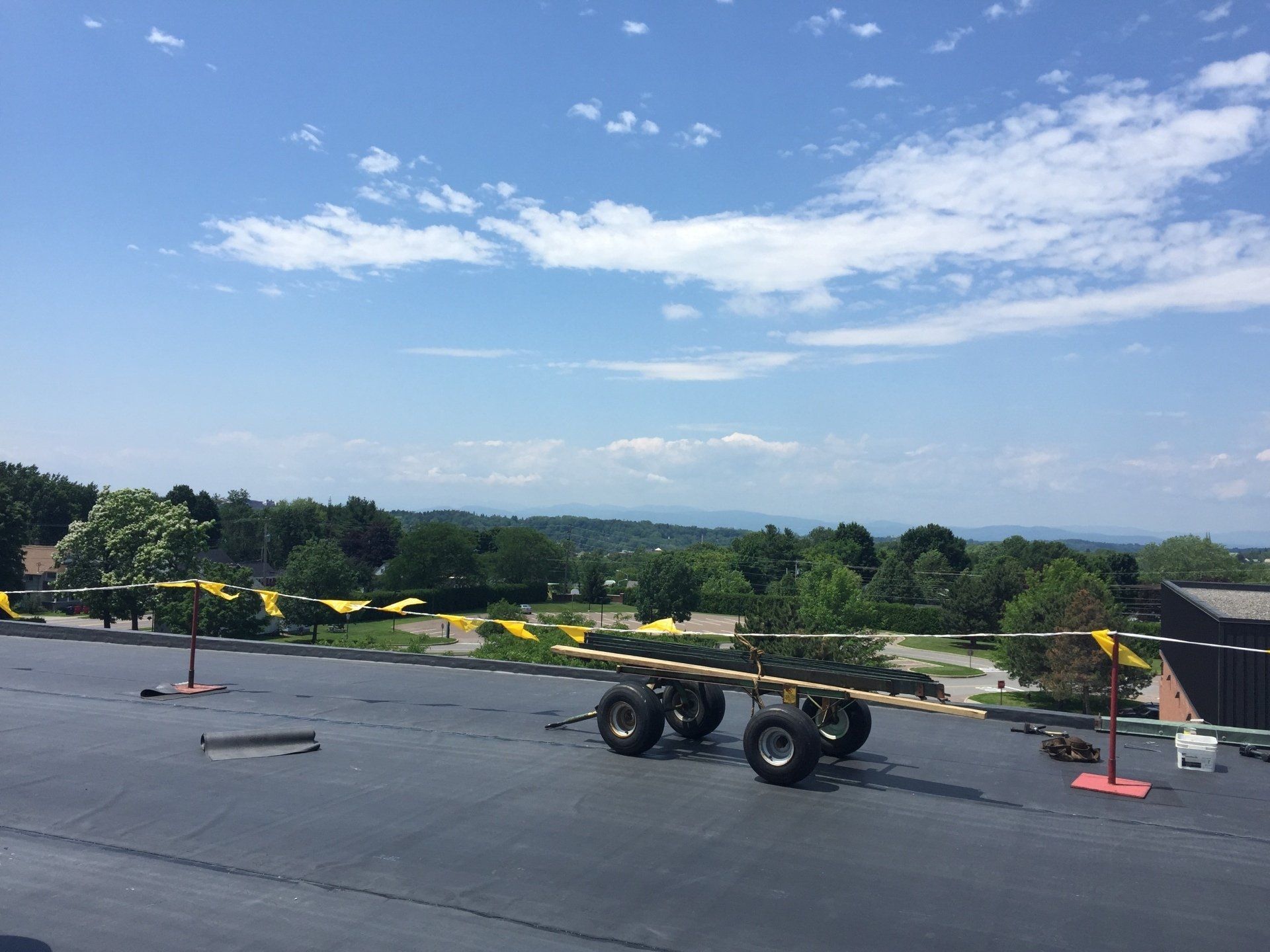 A large trailer is sitting on the roof of a building.