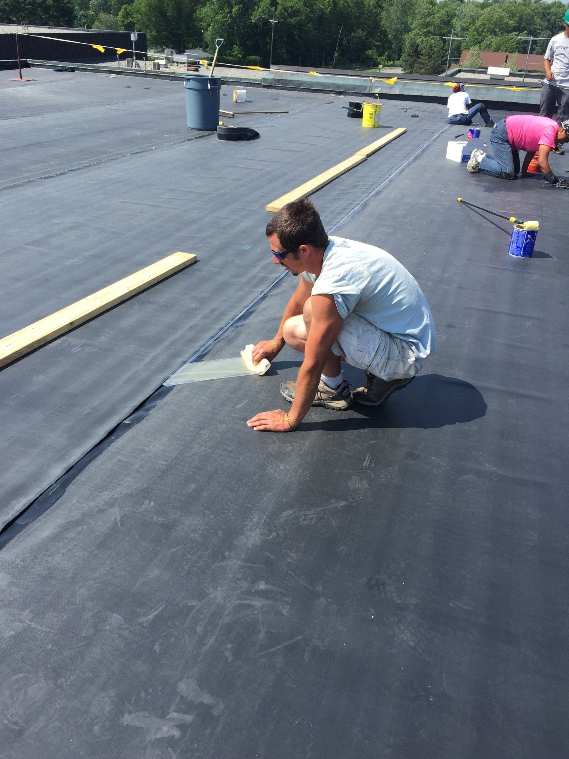 A Rodd Roofing employee prepping a commercial roof