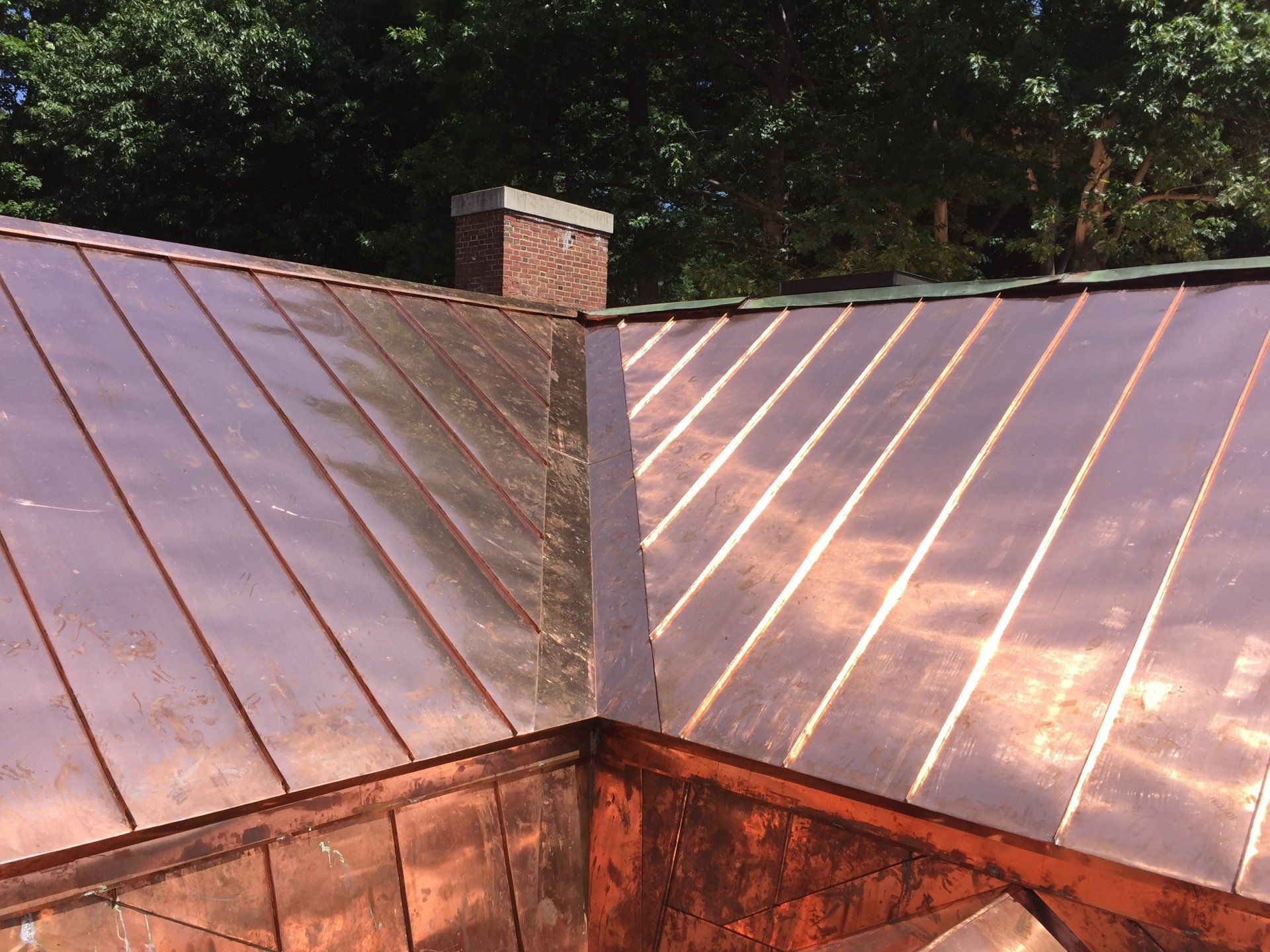A copper roof with a chimney on top of it
