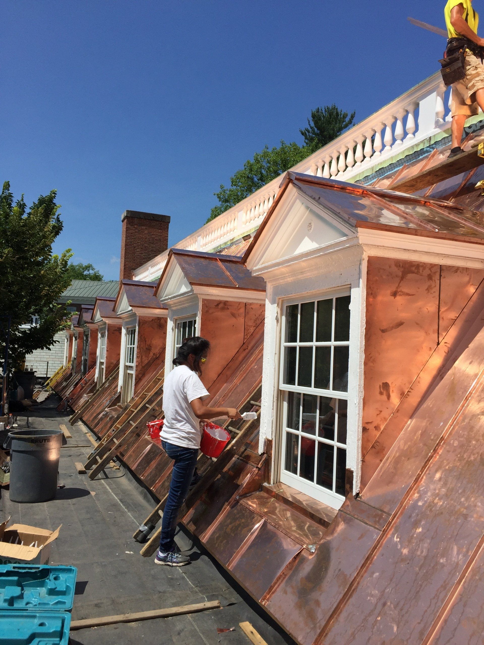 Rodd Roofing employees installing a copper roof on a commercial budling