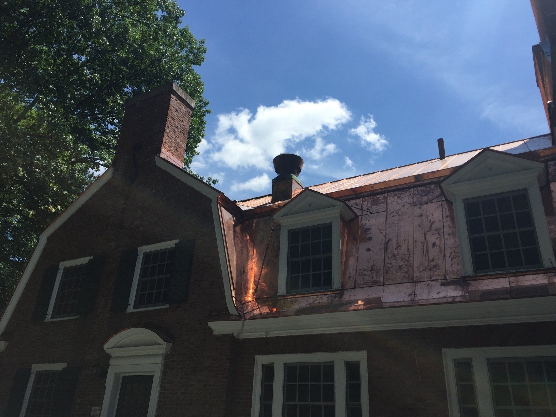A brick house with a chimney on the roof