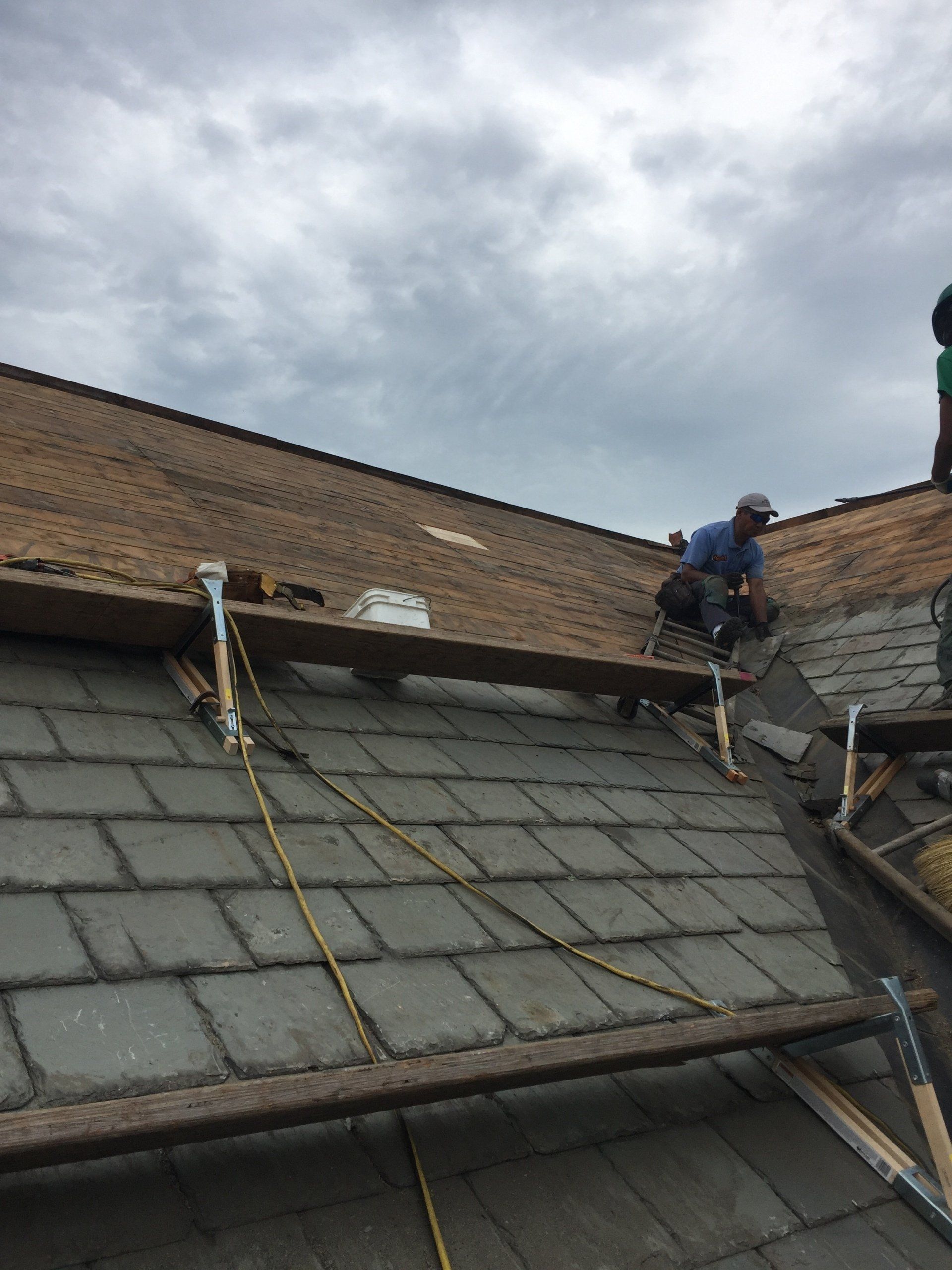 Rodd roofing employees installing a slate roof
