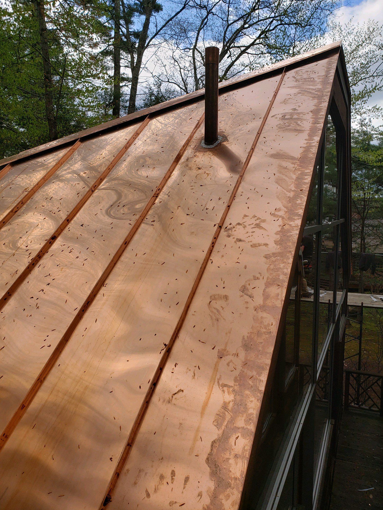 A copper roof with a chimney on top of it