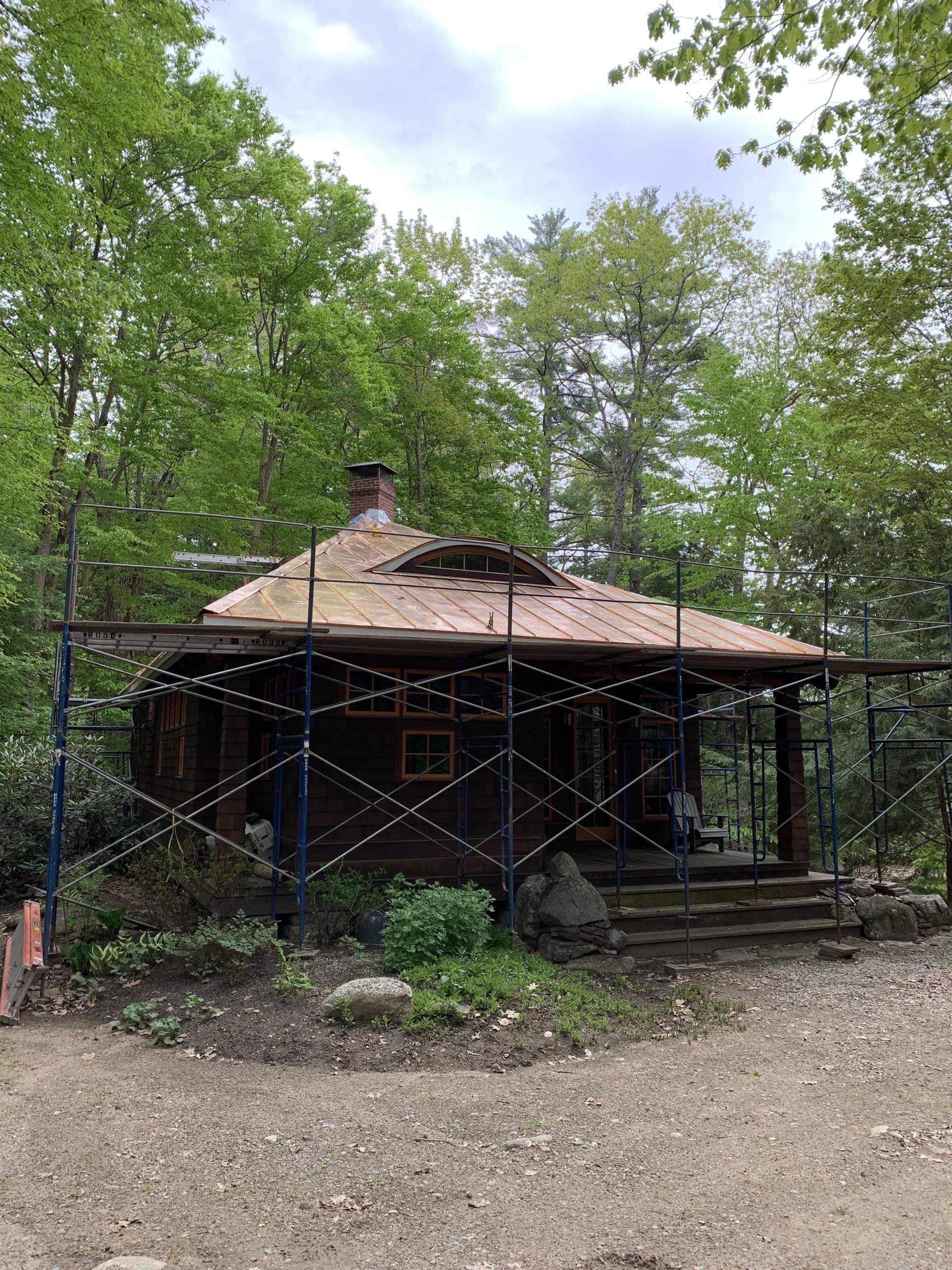 A house is being remodeled with scaffolding around it.