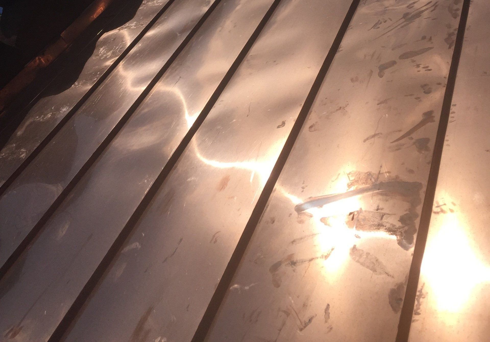 A close up of a copper roof with the sun shining on it