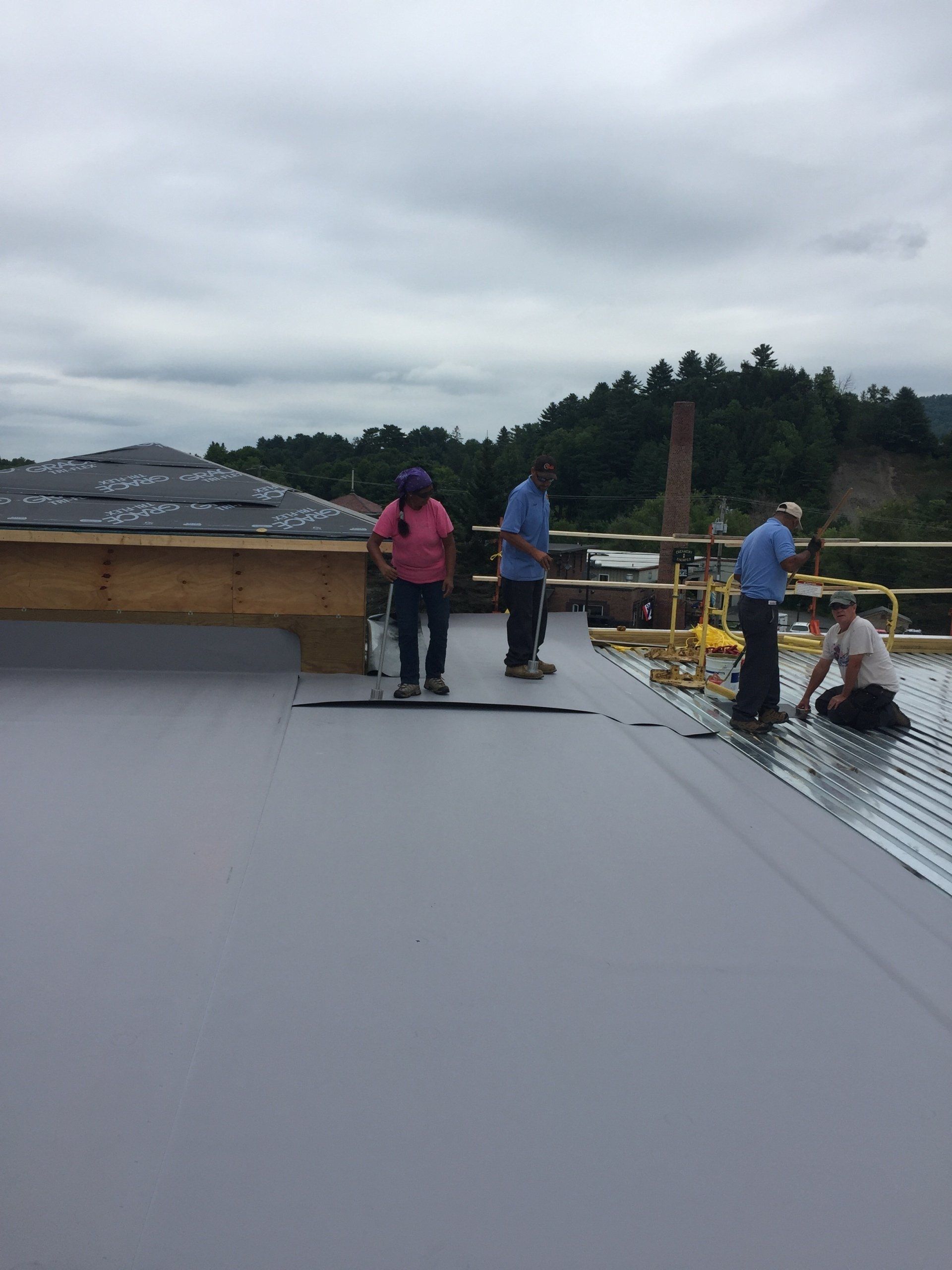 A group of people are working on a roof.