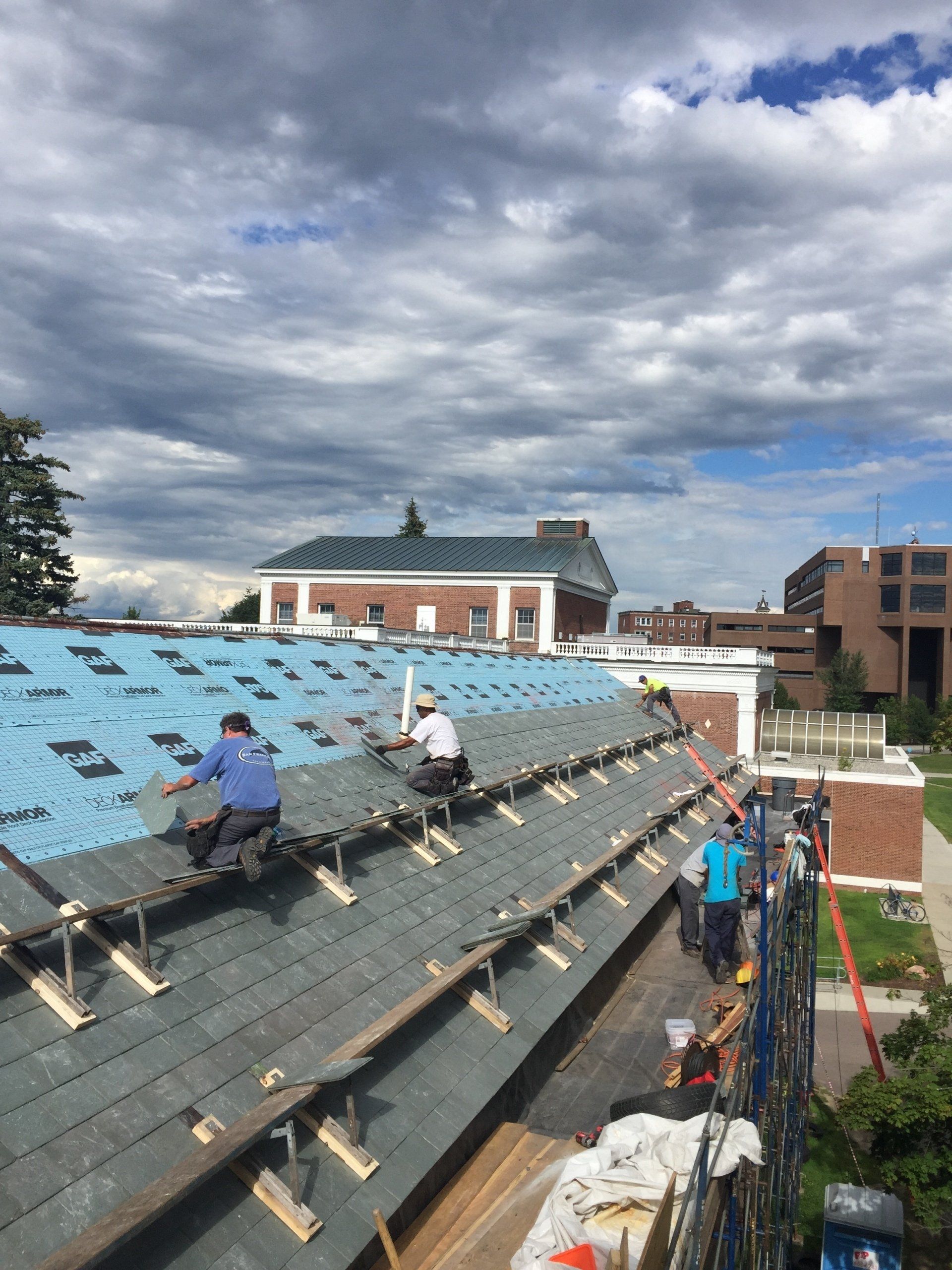 A team from Rodd Roofing installs slate shingles on a commercial building in Burlington, Vermont