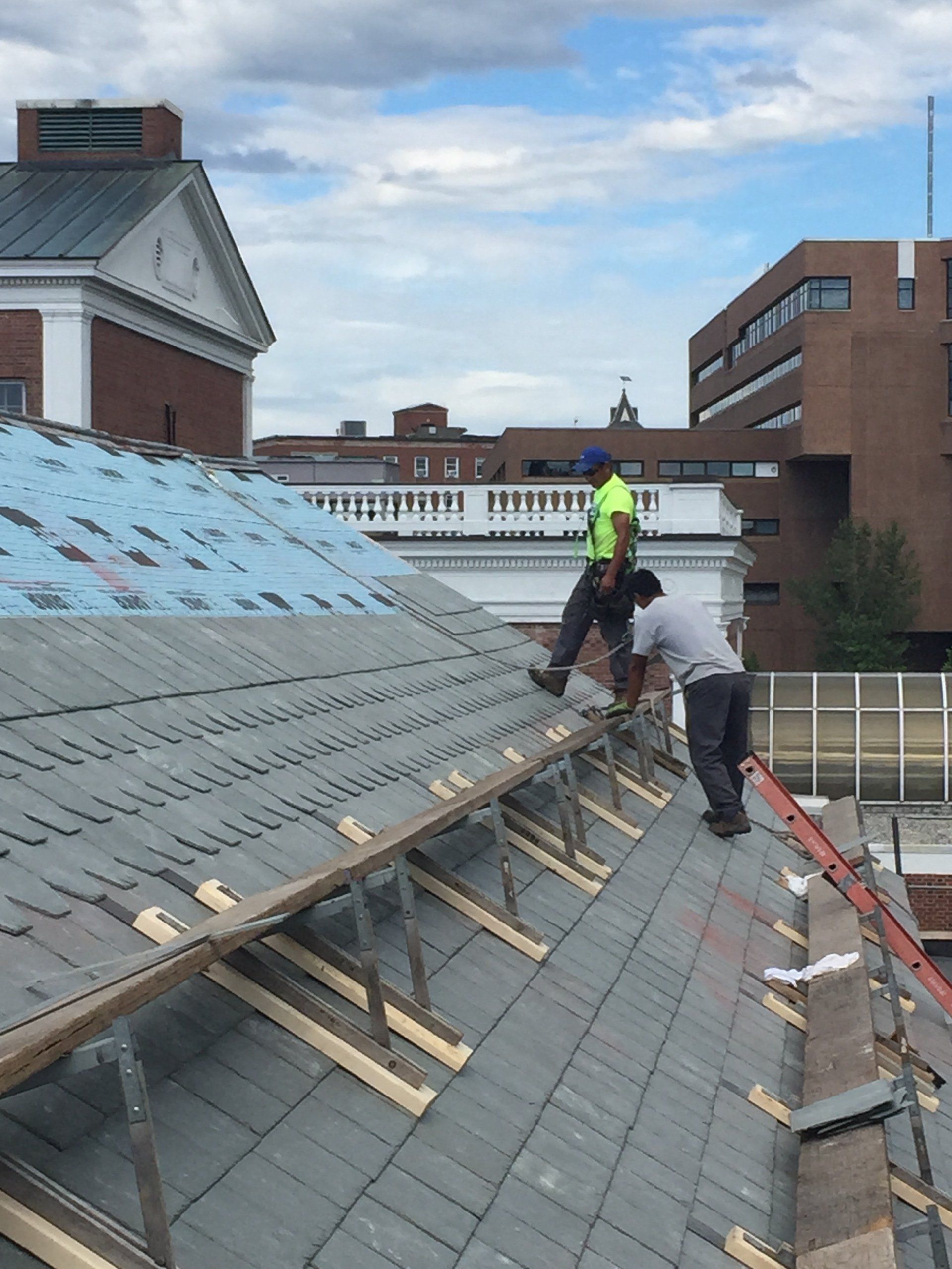 Rodd Roofing slate roof workers work to install a slate roof in Burlington
