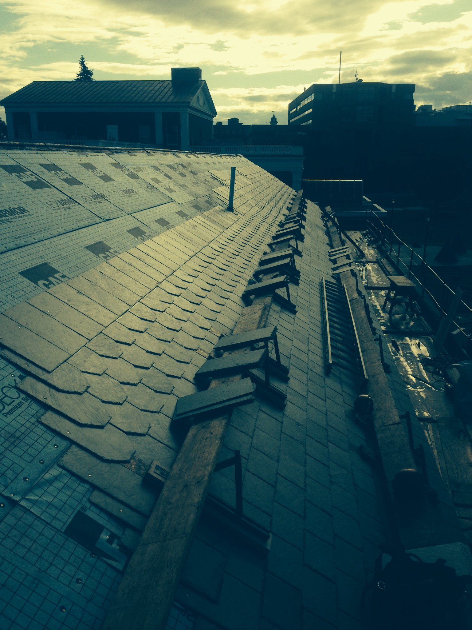 A commercial roof with a Vermont slate roofing project in progress by Rodd Roofing, custom vt roofing solutions contractor