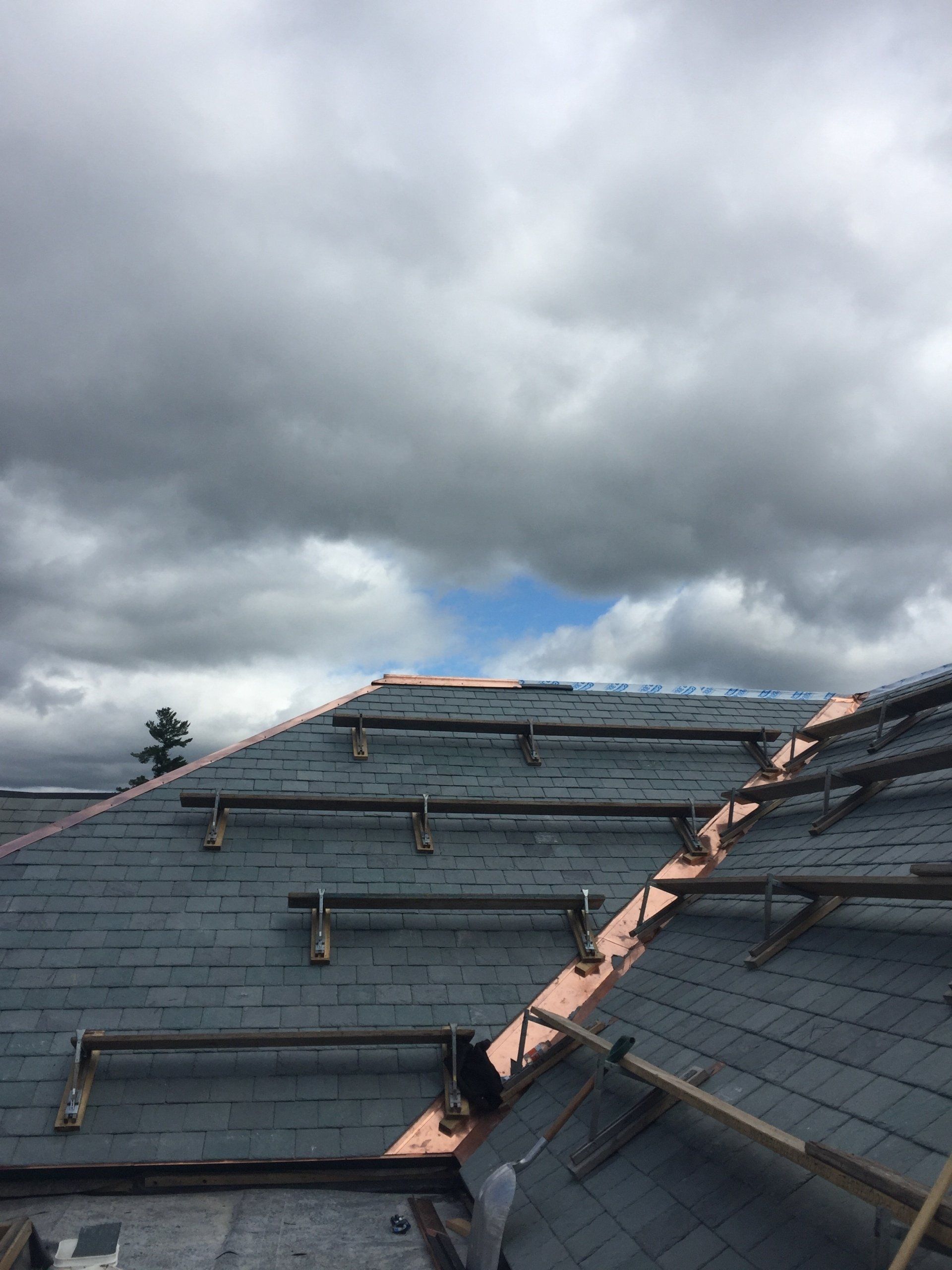 Rodd Roofing installing a slate roof with copper valleys and trim