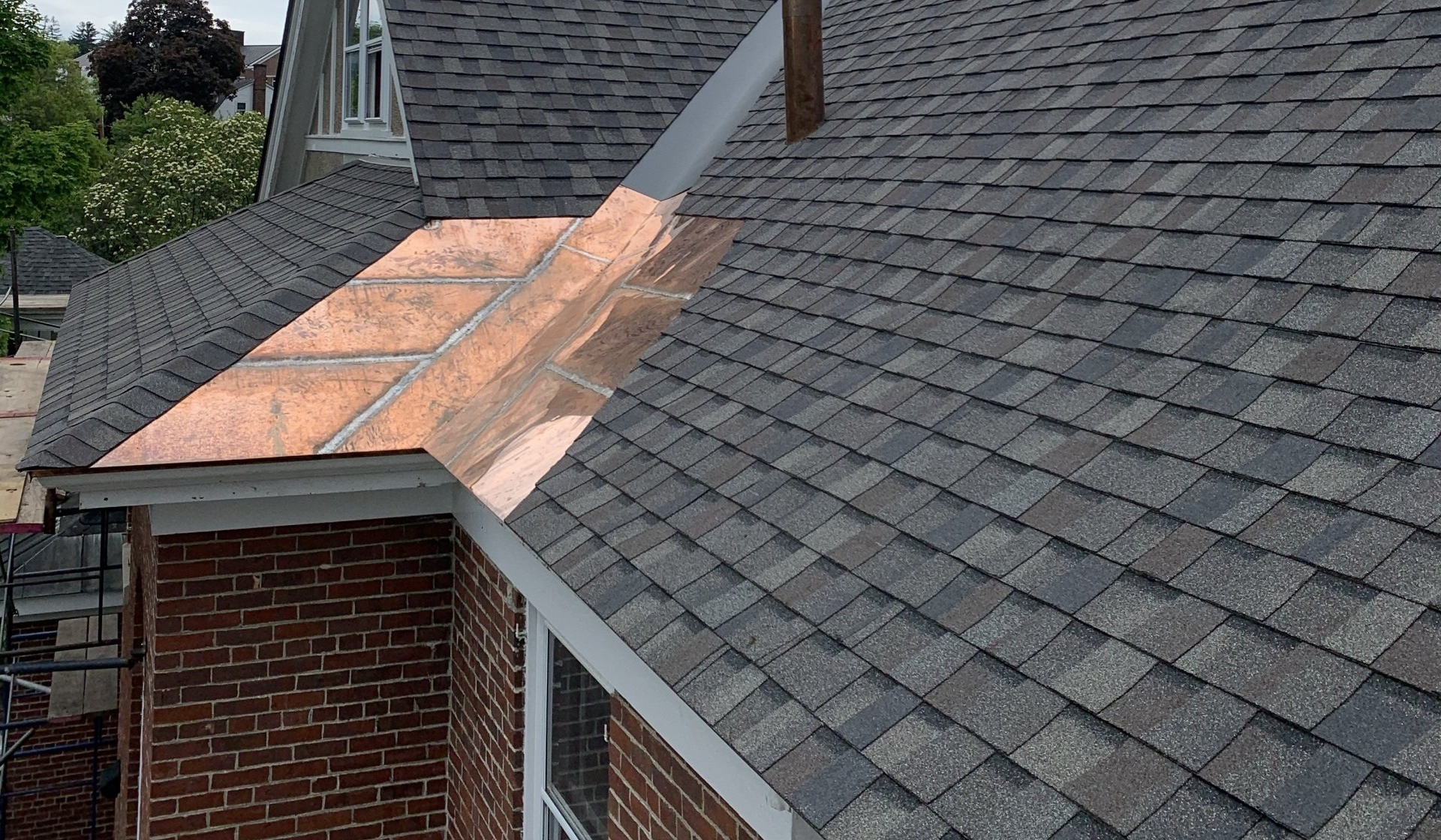 An Asphalt Shingle and Copper Seam roof expertly installed by Rodd Roofing in Vermont