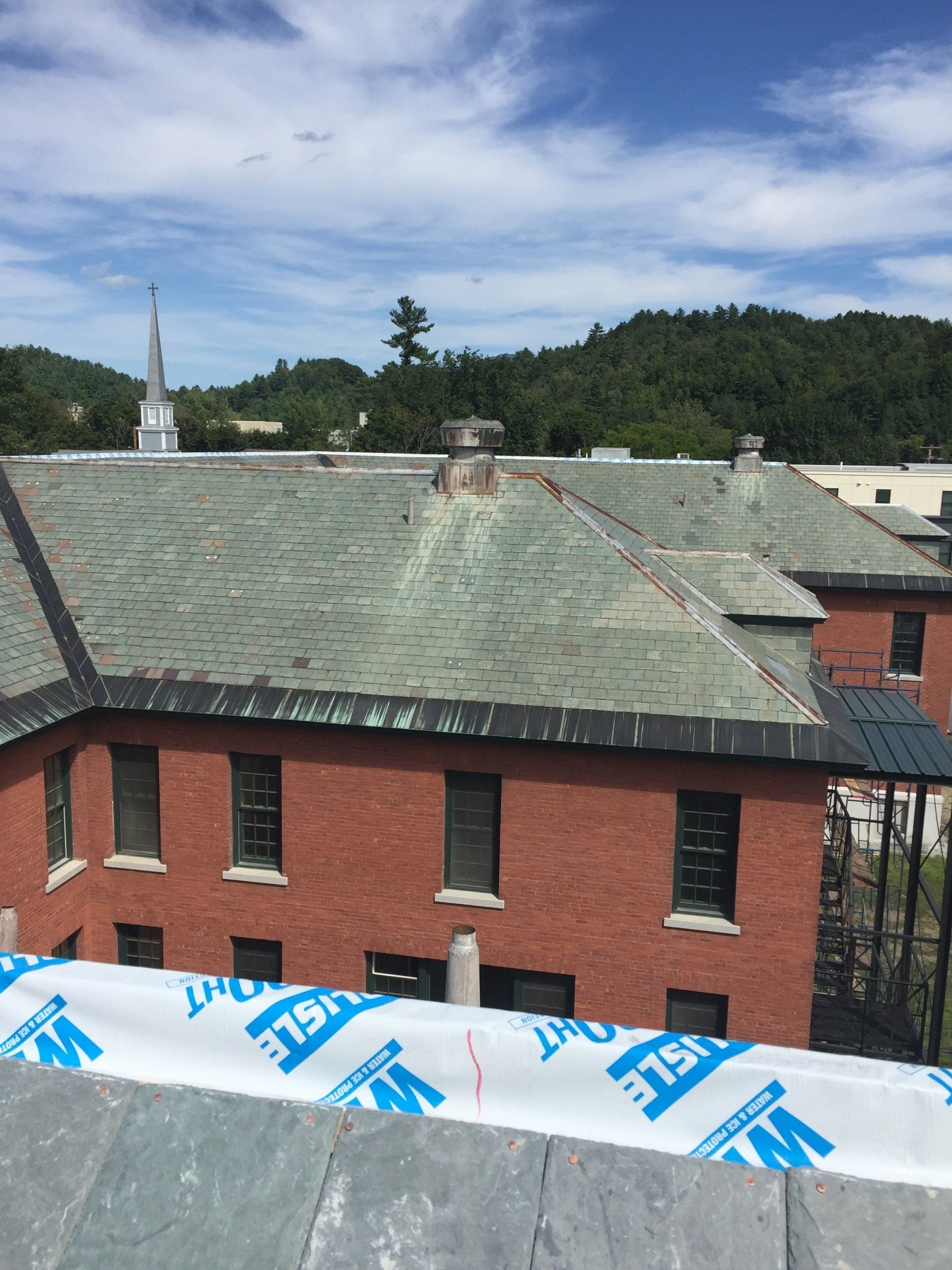 A brick building with a roof that has shingles on it