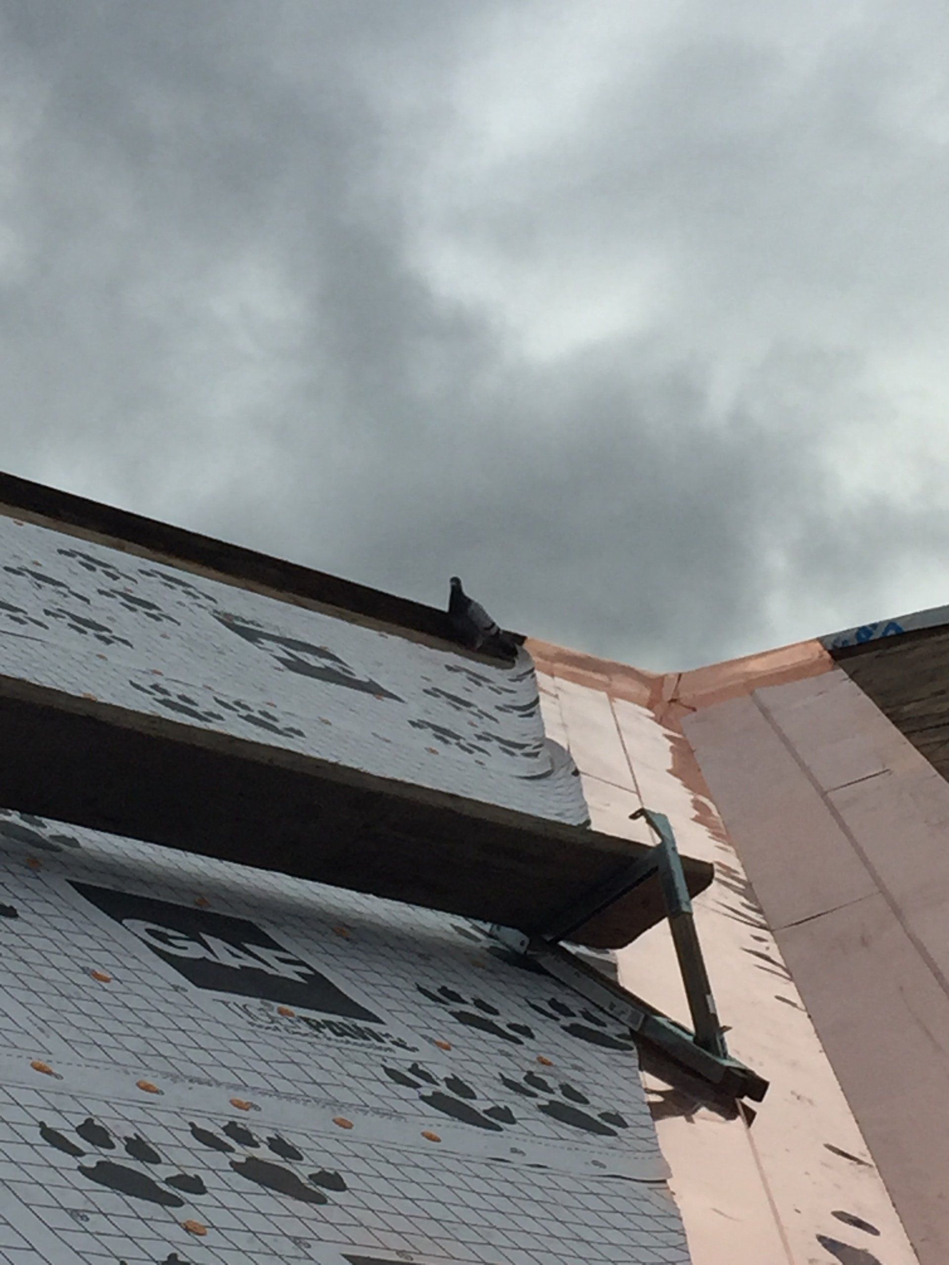 A building under construction with a cloudy sky in the background