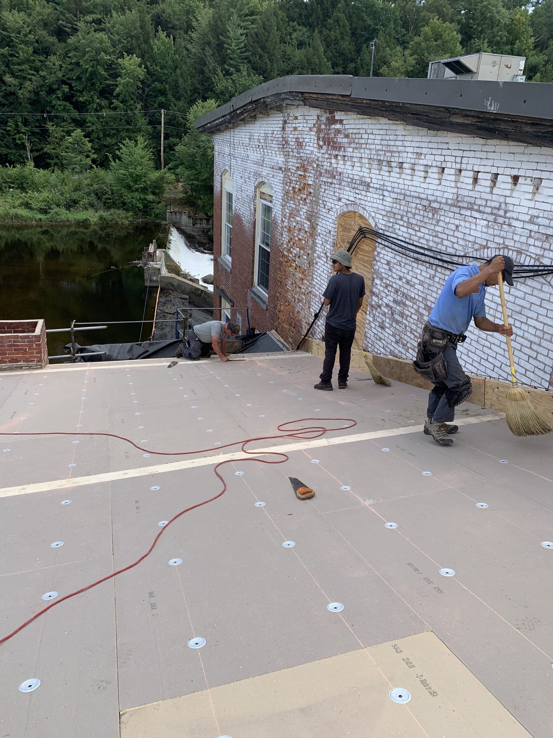 Rodd Roofing employees installing a new single ply roof on a commercial building