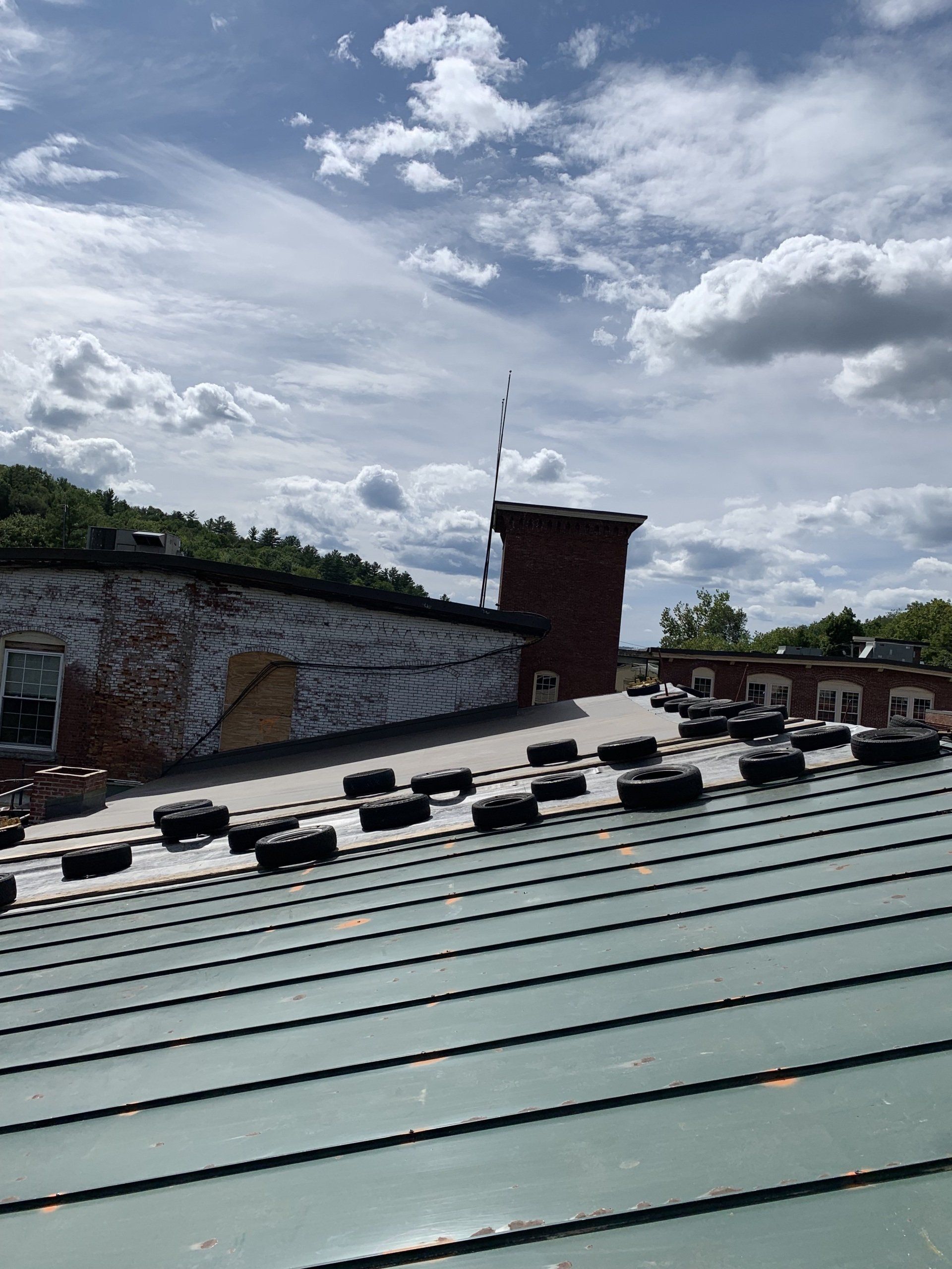 The roof of a building with a lot of tires on it