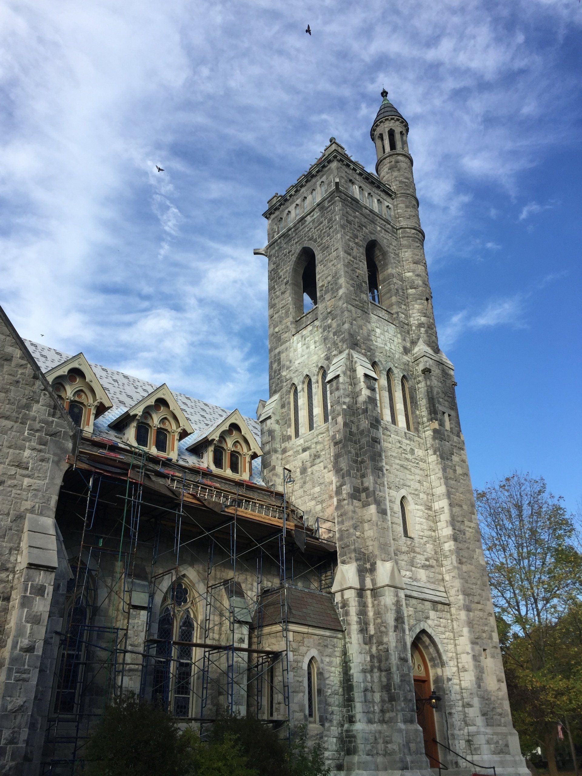 Large stone cathedral with asphalt shingles roof
