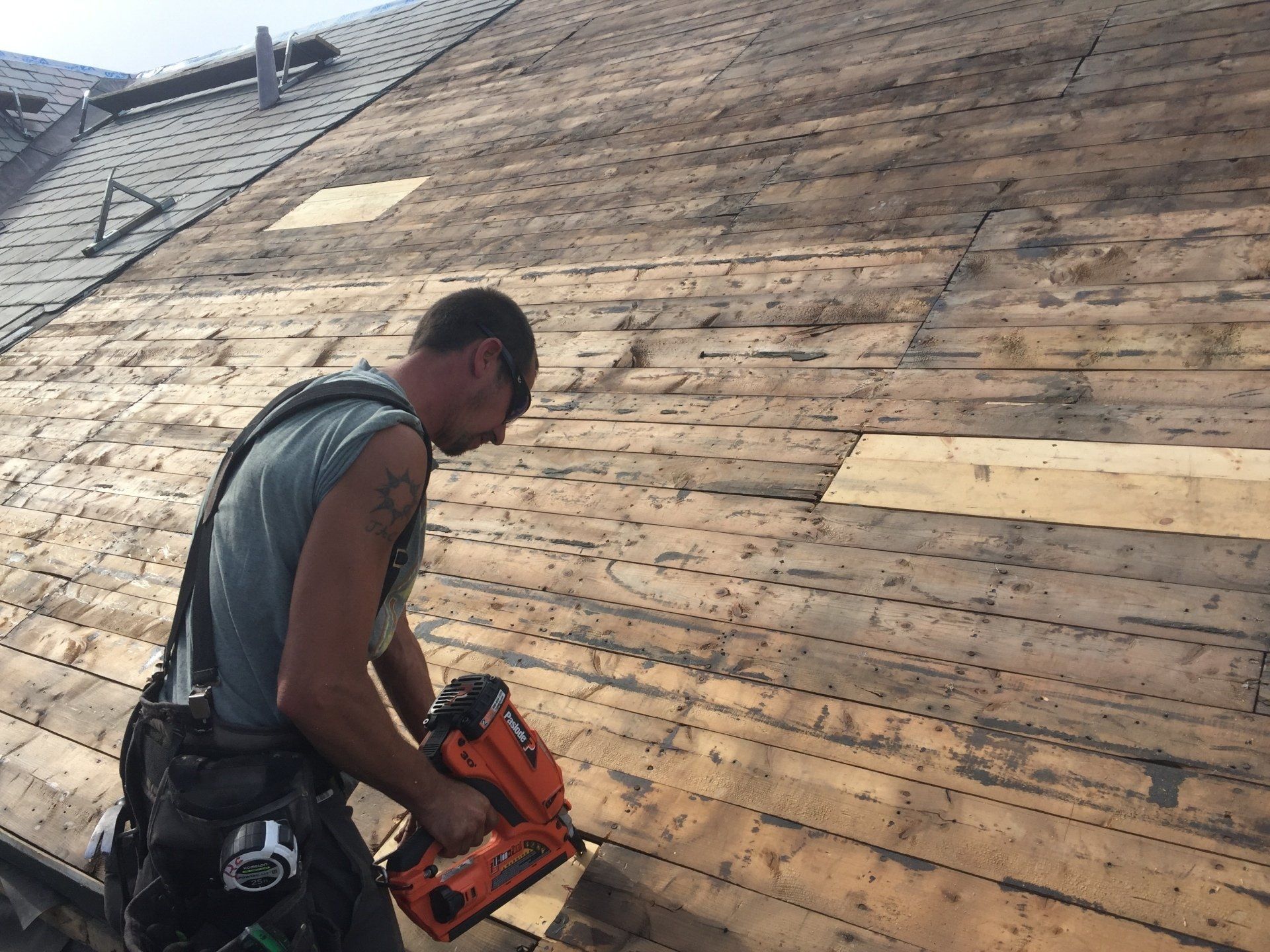 A Rodd Roofing employee installing a new roof on a home in Vermont