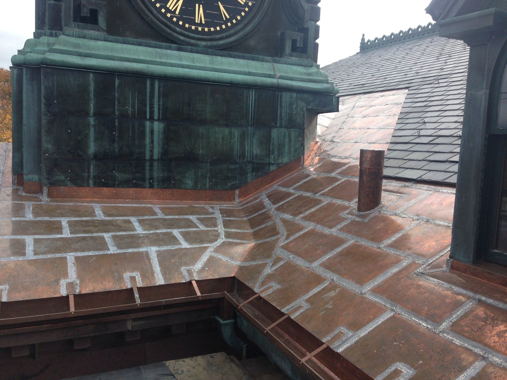 A clock on top of a building with roman numerals