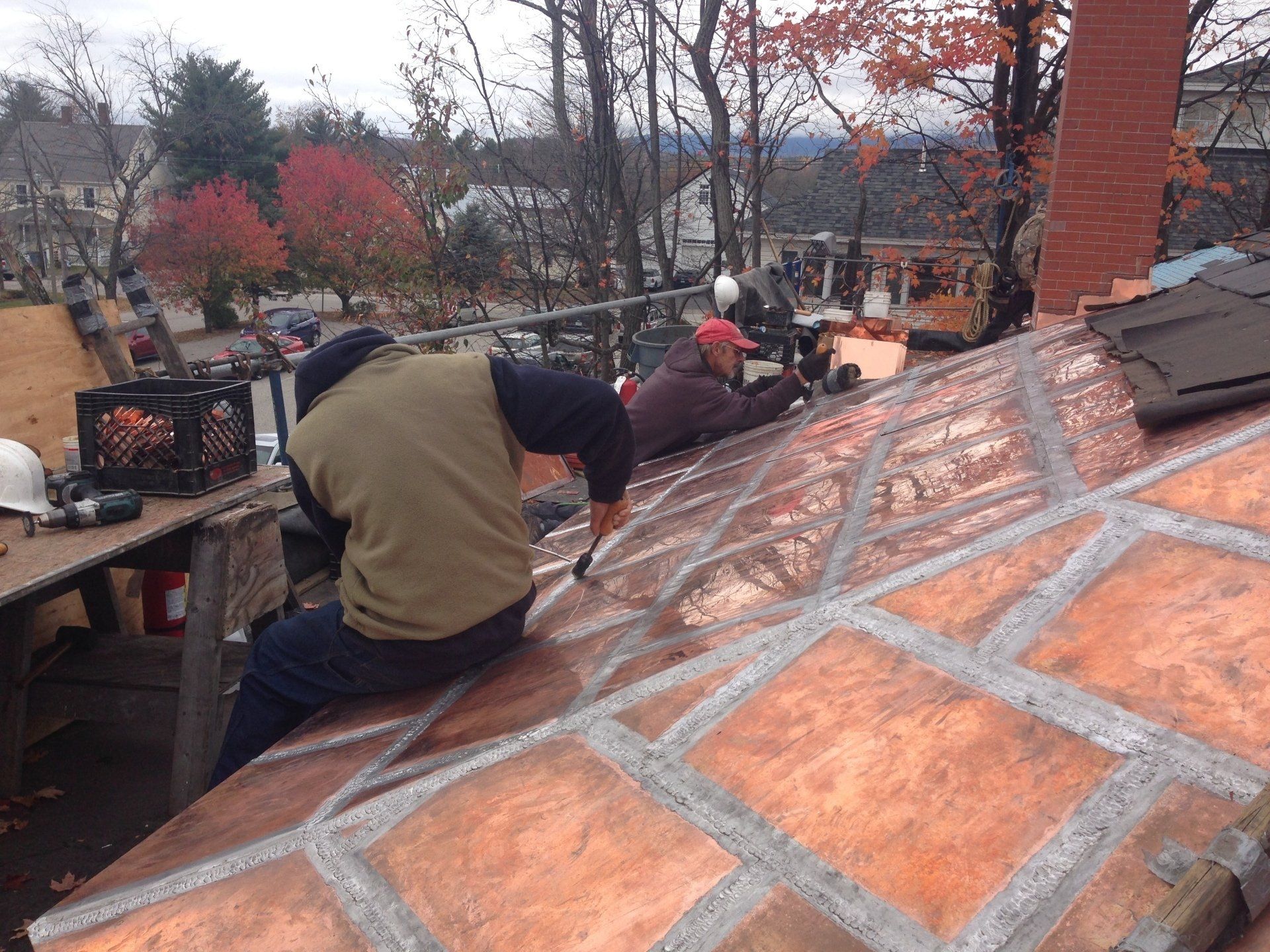 Asphalt and copper roof being worked on by Vermont Roofer