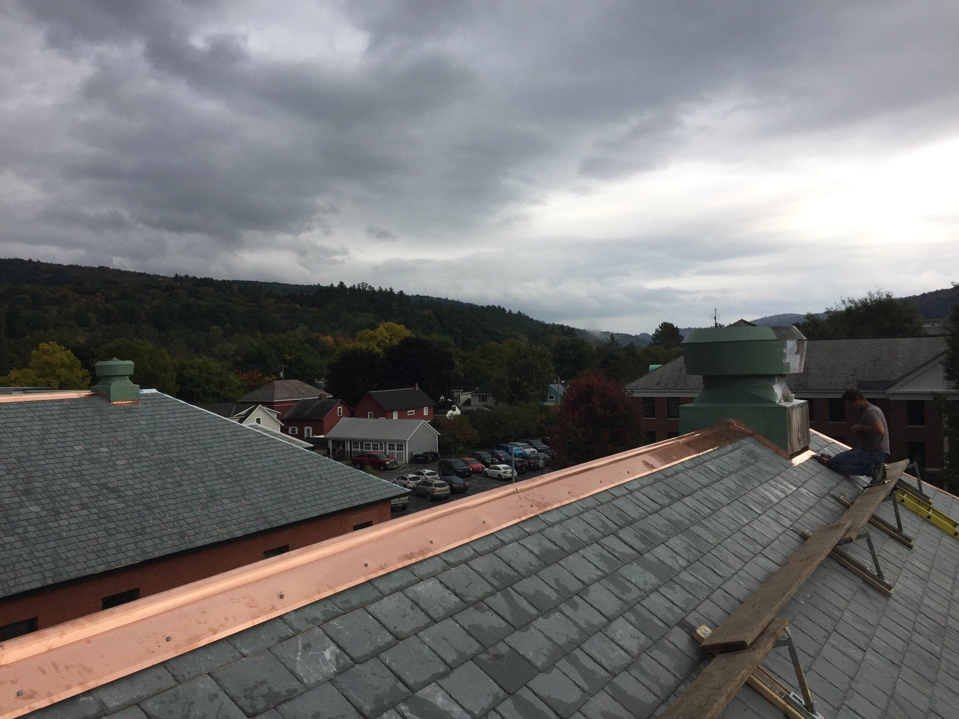 A man is working on the roof of a building