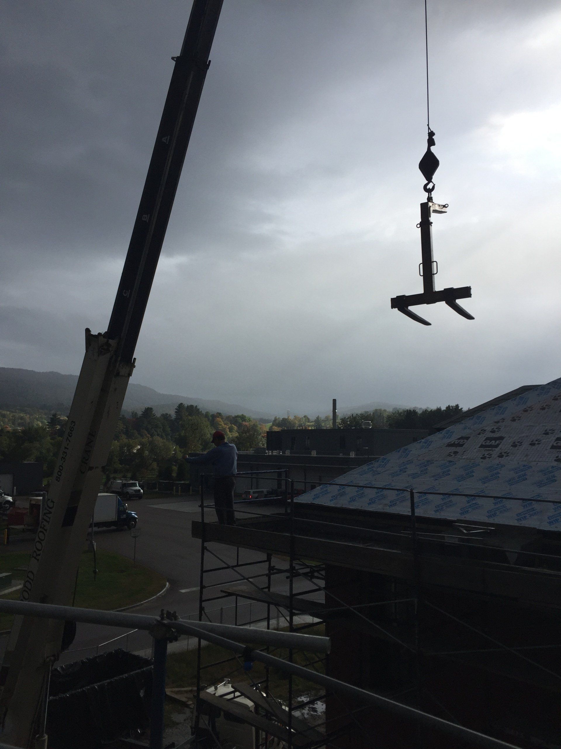 Rood Roofing crane working on the slate roof